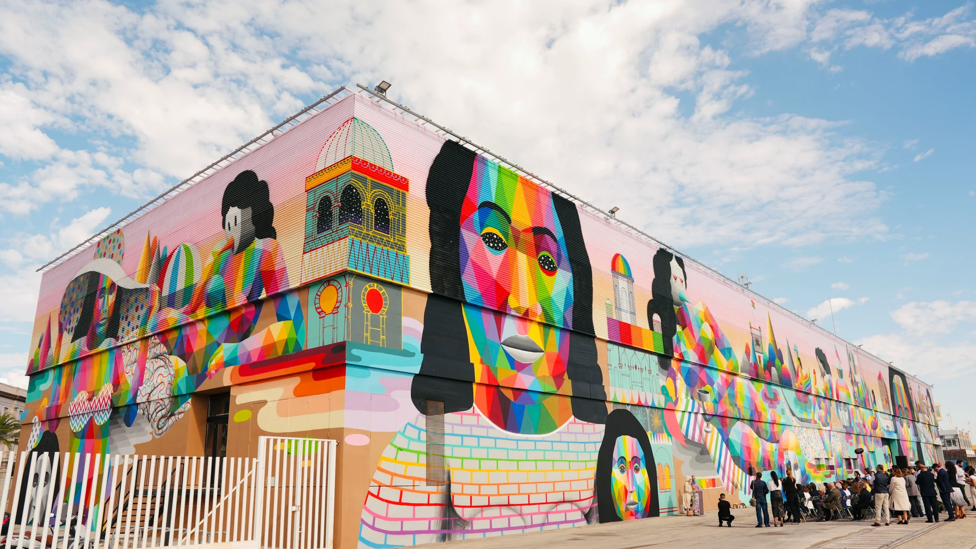 CÁDIZ, 24/10/2024.- El artista cántabro Óscar San Miguel, conocido como Okuda San Miguel, ha presentado este jueves el mural de arte urbano que ha realizado en la fachada de un almacén del Muelle Alfonso XIII del puerto de Cádiz. Una obra con las características figuras coloridas del artista que dará la bienvenida a la ciudad a los barcos y sus pasajeros y tripulantes. EFE/Román Ríos