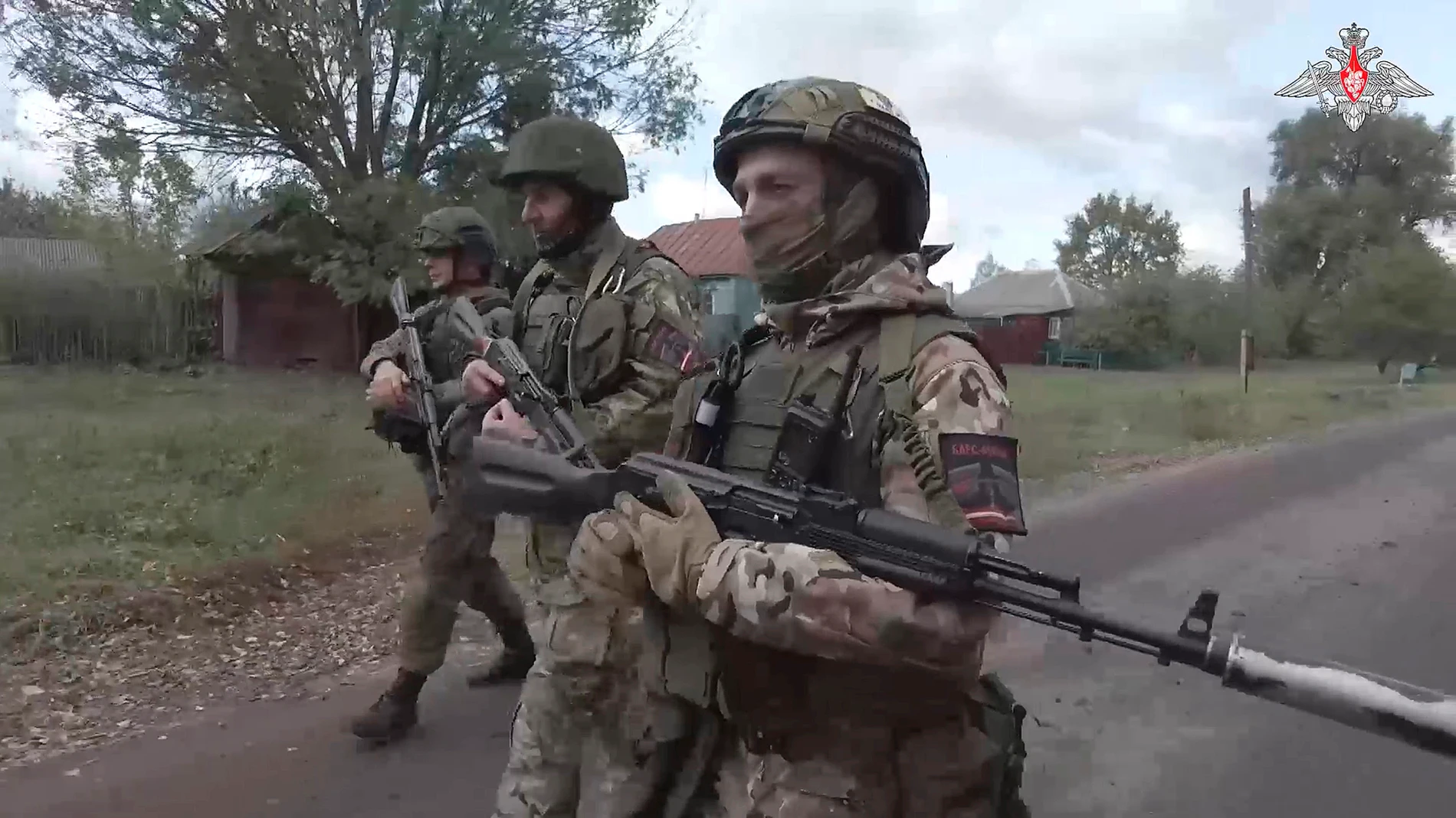 In this photo taken from video released by the Russian Defense Ministry on Thursday, Oct. 24, 2024, Russian soldiers patrol a village in the Russian - Ukrainian border area in the Kursk region, Russia. (Russian Defense Ministry Press Service photo via AP)