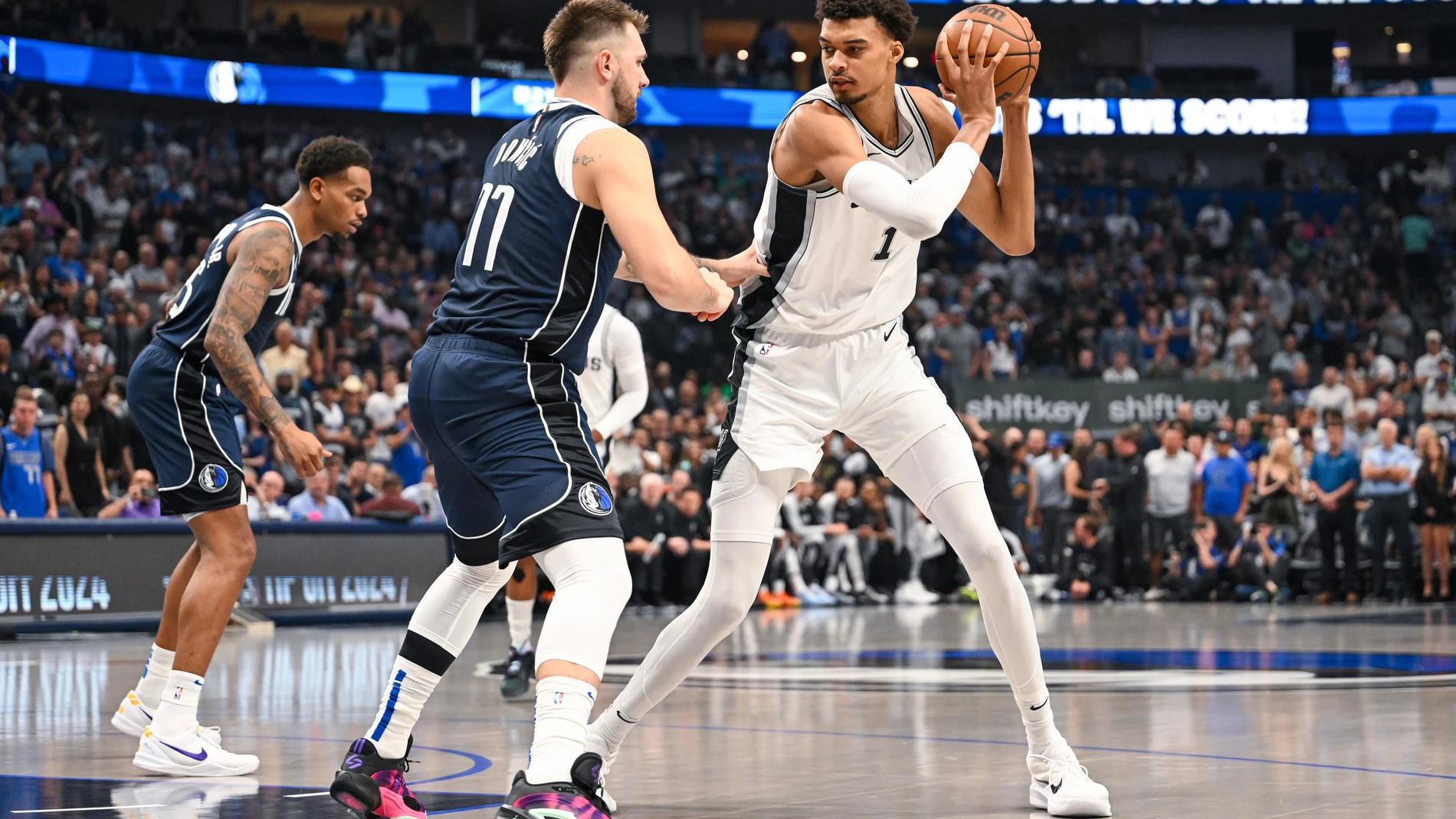 San Antonio Spurs' Victor Wembanyama, right, is defended by Dallas Mavericks' guard Luka Doncic, front left, during the first half of an NBA basketball game, Thursday, Oct. 24, 2024, in Dallas, Texas. (AP Photo/Albert Pena)