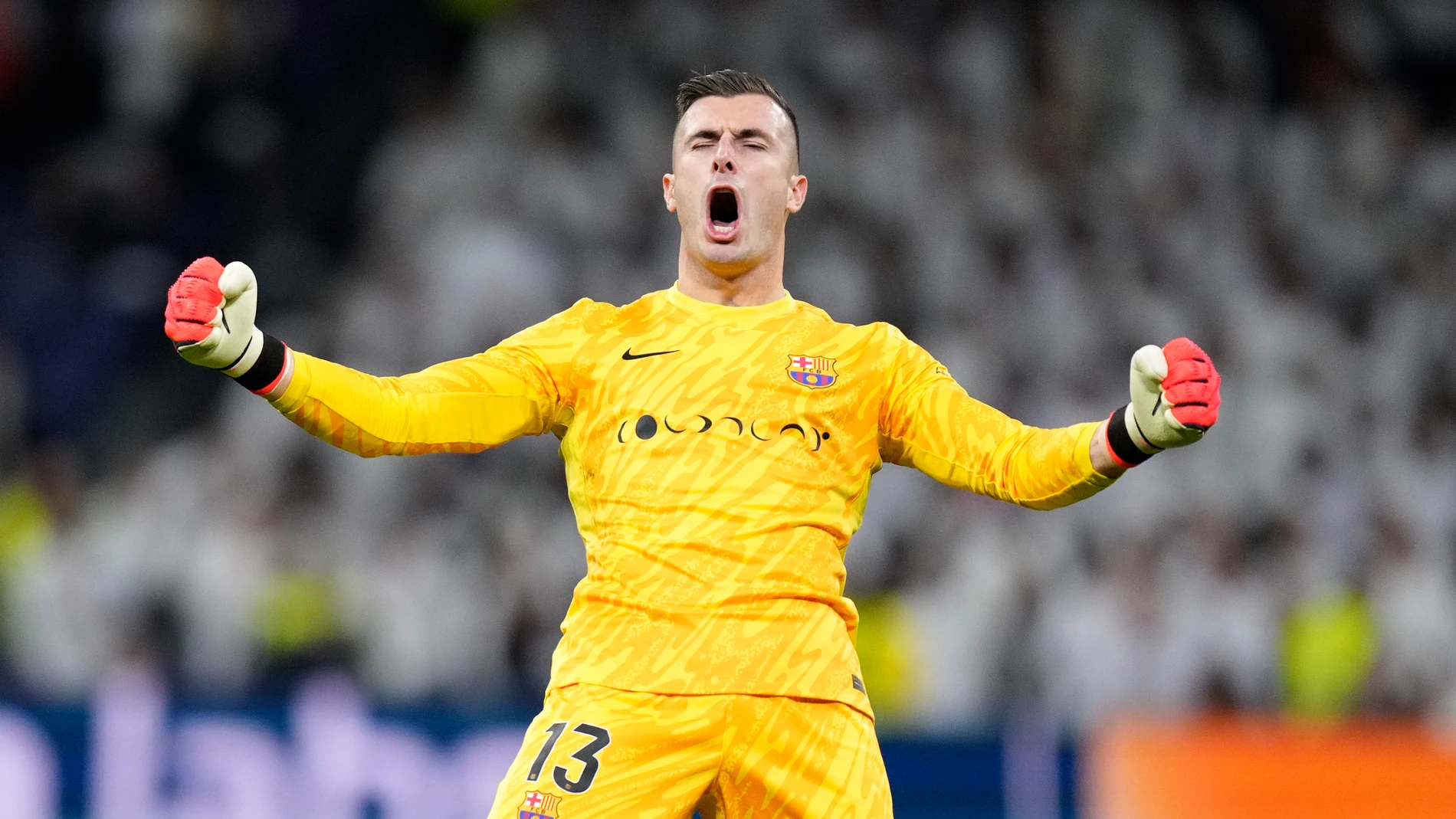 Barcelona's goalkeeper Inaki Pena celebrates at the end of a Spanish La Liga soccer match between Real Madrid and Barcelona at the Santiago Bernabeu stadium in Madrid, Spain, Saturday, Oct. 26, 2024. (AP Photo/Bernat Armangue)