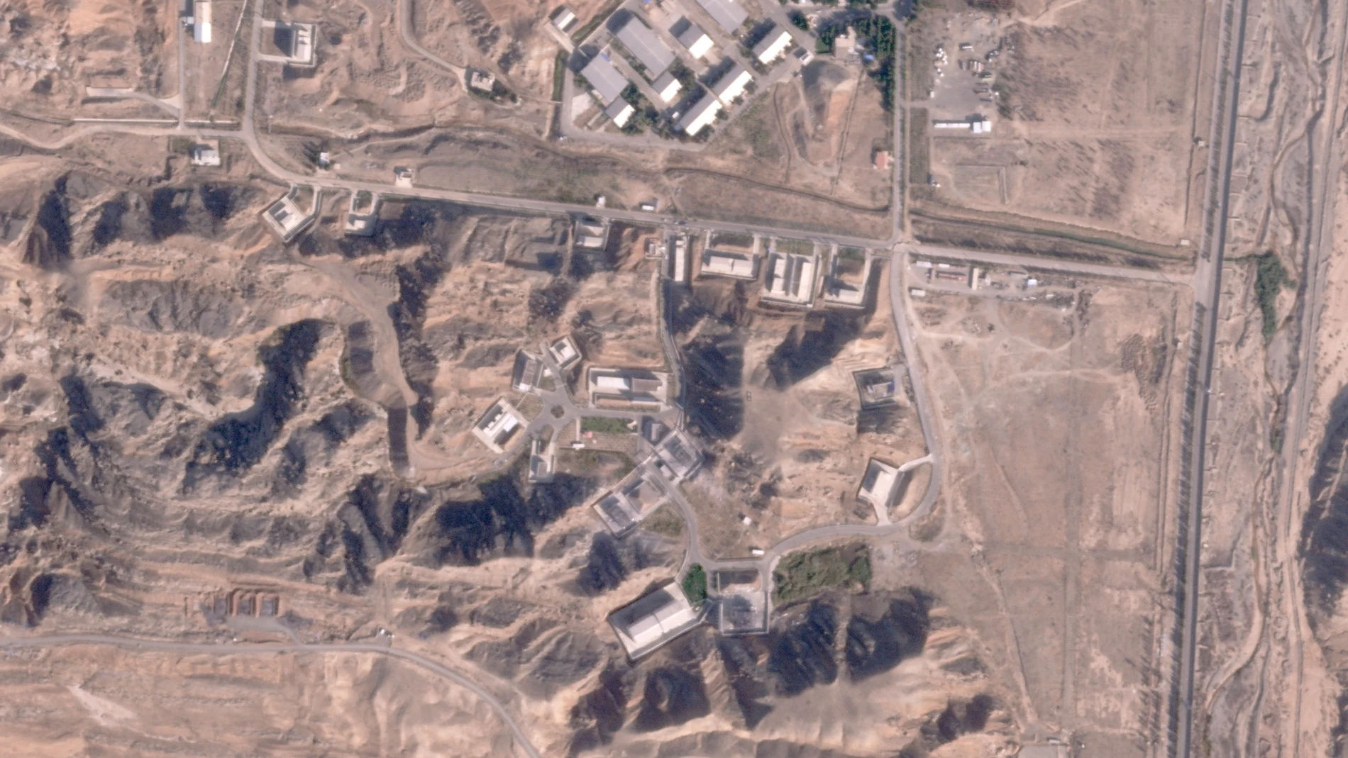 This satellite photo from Planet Labs PBC shows damaged buildings at Iran's Parchin military base outside of Tehran, Iran, Sunday, Oct. 27, 2024. An Israeli attack on Iran damaged facilities at a secretive military base southeast of the Iranian capital that experts in the past have linked to Tehran's onetime nuclear weapons program and at another base tied to its ballistic missile program, satellite photos analyzed Sunday by The Associated Press show. The damaged structures are in the bottom ...