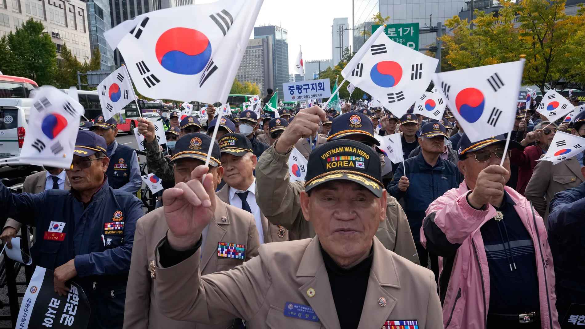 Members of the Korean Vietnam War Veterans Association wave national flags during a rally against a recent deployment of North Korean troops to Russia, in Seoul, South Korea, Monday, Oct. 28, 2024. (AP Photo/Ahn Young-joon)