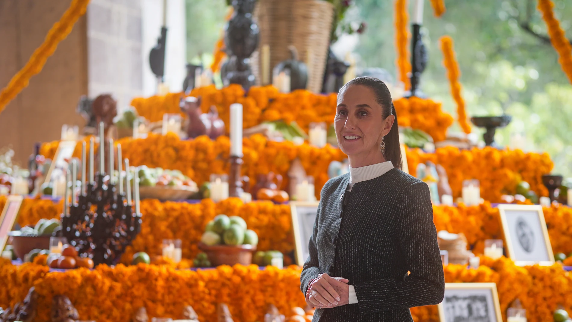 Handout picture released by the Mexican Presidency showing President Claudia Sheinbaum posing in front an altar during the commemoration of the Day of the Dead at the National Palace in Mexico City on November 1, 2024.