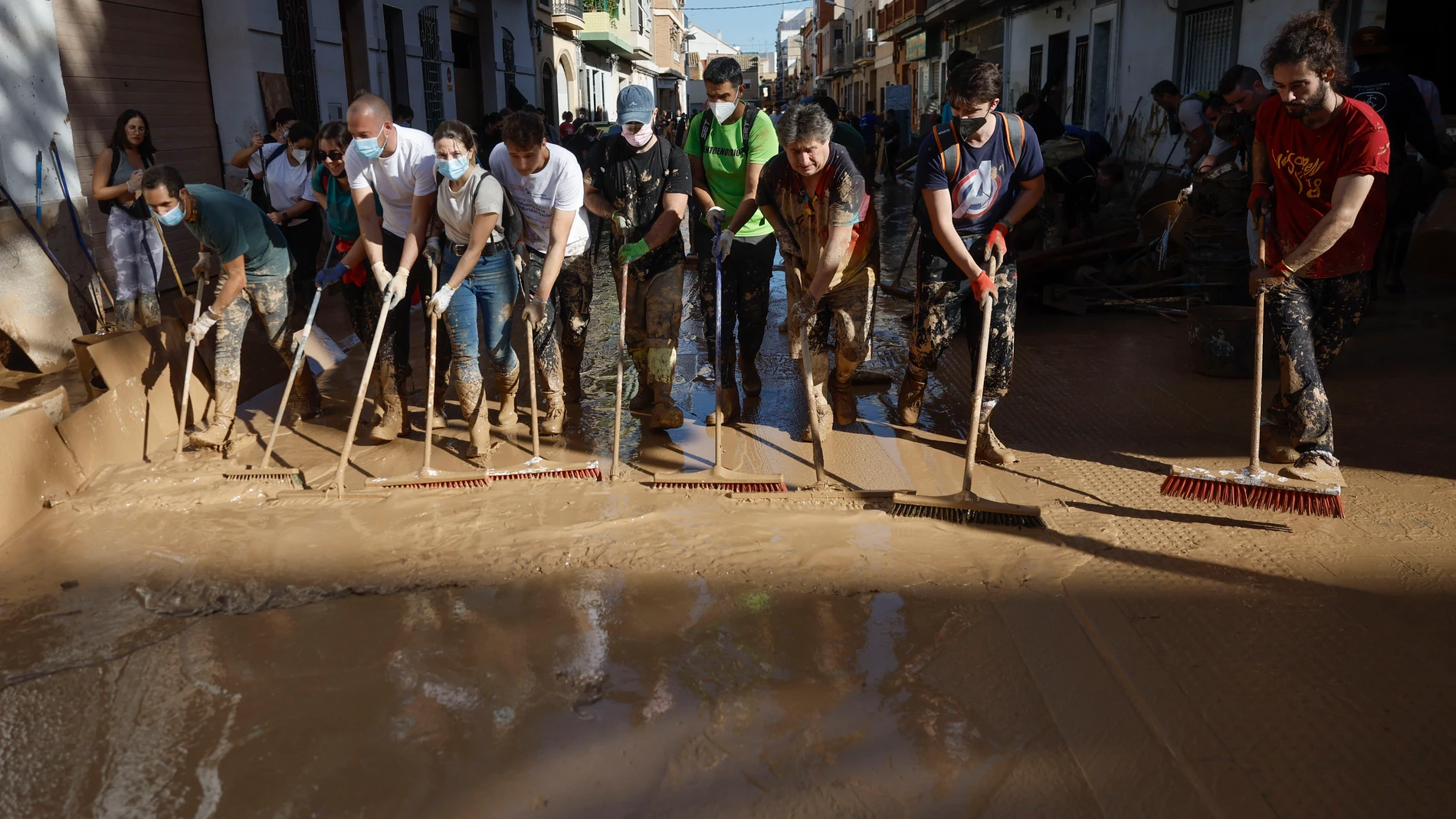 PAIPORTA (VALENCIA), 02/11/2024.- Varias personas trabajan en las labores de limpieza en la localidad valenciana de Paiporta, este sábado. Por tercer día consecutivo una marea de voluntarios ha llegado este sábado a barrios del sur de la ciudad de València y a los pueblos de la comarca vecina de l’Horta Sud asolados por la dana para luchar contra un fango, donde grupos especializados de los equipos de intervención buscan cadáveres en garajes o fosos aún anegados.EFE/ Kai Försterling