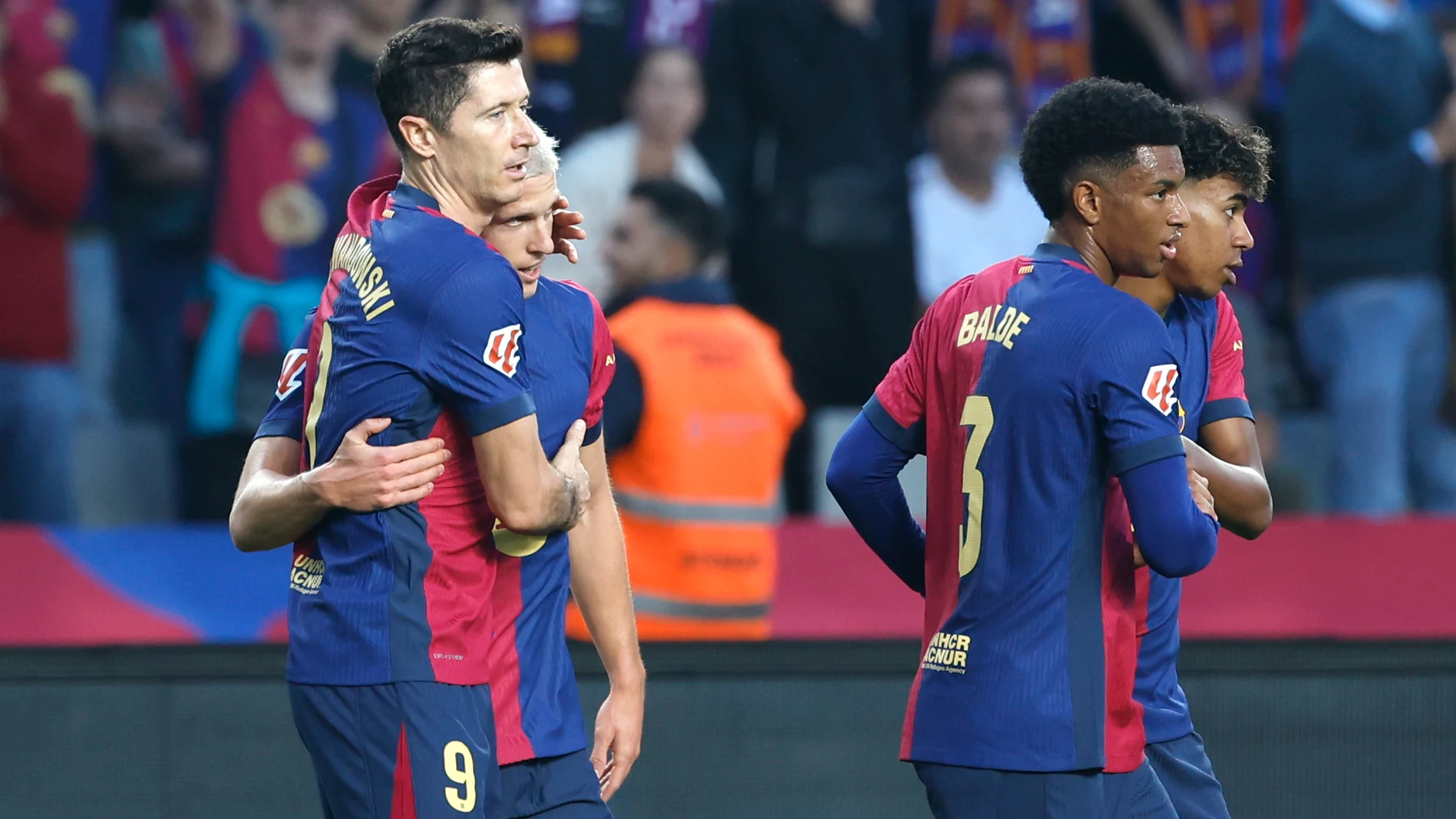 Barcelona's Dani Olmo, second left, celebrates with Barcelona's Robert Lewandowski after scoring his side's opening goal during a Spanish La Liga soccer match between Barcelona and Espanyol at the Lluis Companys Olympic Stadium in Barcelona, Spain, Sunday, Nov. 3, 2024. (AP Photo/Joan Monfort)