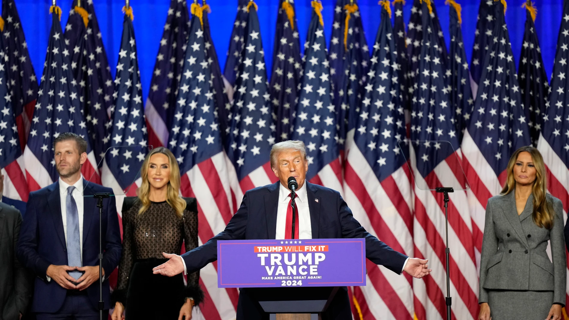 Republican presidential nominee former President Donald Trump speaks at an election night watch party Wednesday, Nov. 6, 2024, in West Palm Beach, Fla., as Eric Trump, Republican National Committee co-chair Lara Trump and Melania Trump listen. (AP Photo/Alex Brandon)