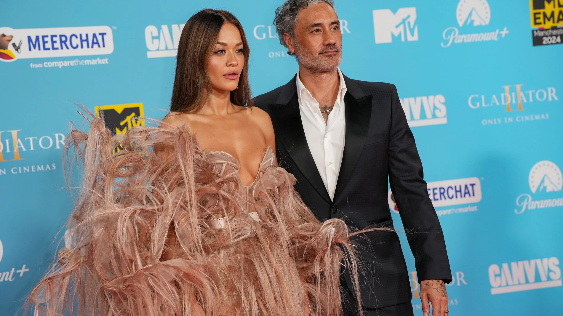 Rita Ora, left, and Taika Waititi pose for photographers upon arrival at the MTV European Music Awards 2024 in Manchester, England, Sunday, Nov. 10, 2024. (Scott A Garfitt/Invision/AP)