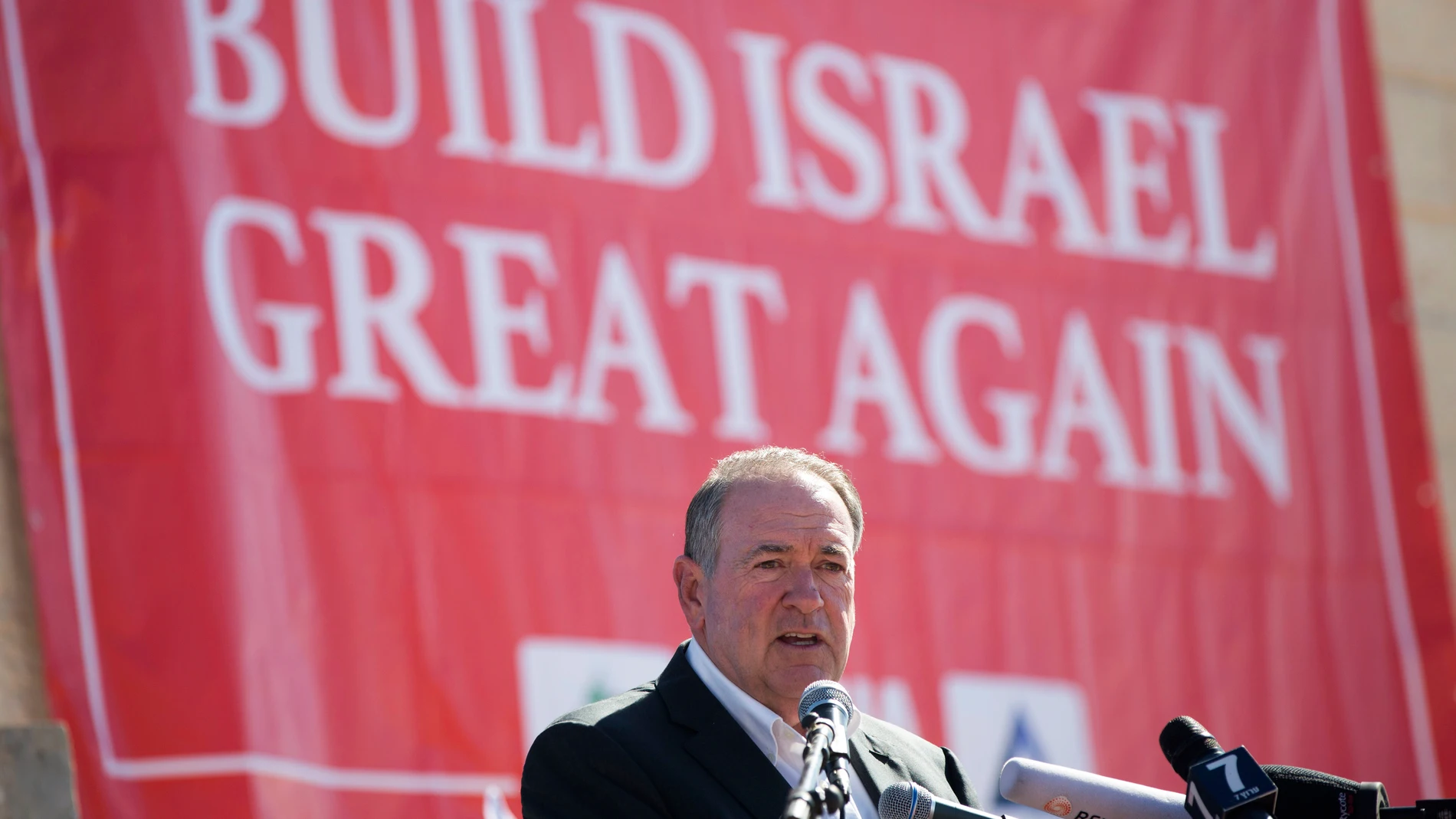 FILE - Gov. Mike Huckabee, R-Ark., takes questions from the media, prior to laying a brick at a new housing complex in the West Bank settlement of Efrat, Aug. 1, 2018. President-elect Donald Trump will nominate former Arkansas Gov. Mike Huckabee as ambassador to Israel. Trump said Tuesday that Huckabee is a staunch defender of Israel and his intended nomination comes as Trump has promised to align U.S. foreign policy more closely with Israel’s interests as it wages wars against Hamas in Gaza ...