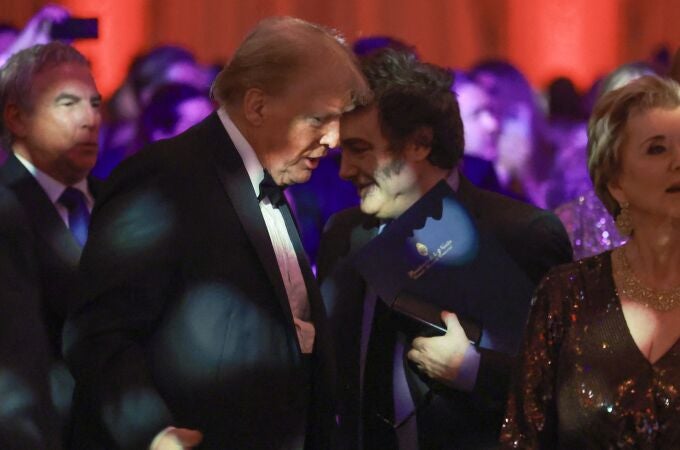 Argentine President Javier Milei walks past U.S. President-elect Donald Trump as they attend the America First Policy Institute Gala held at Mar-a-Lago on November 14, 2024 in Palm Beach, Florida. The annual event supports Grey Team, a nonprofit organization dedicated to preventing military suicide. 