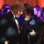 Argentine President Javier Milei walks past U.S. President-elect Donald Trump as they attend the America First Policy Institute Gala held at Mar-a-Lago on November 14, 2024 in Palm Beach, Florida. The annual event supports Grey Team, a nonprofit organization dedicated to preventing military suicide. 