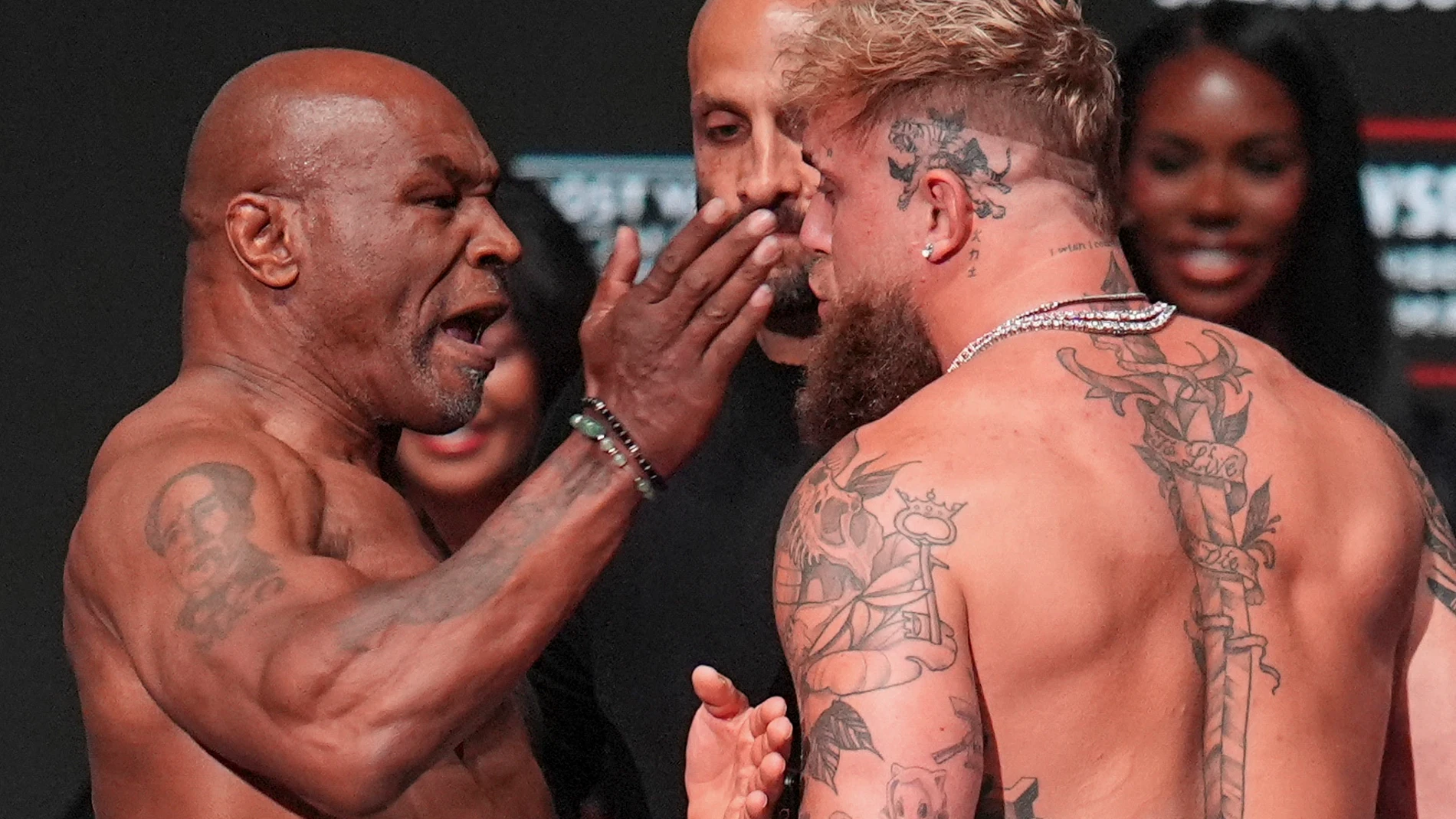 Mike Tyson, left, slaps Jake Paul during the weigh-in ahead of their heavyweight bout, Thursday, Nov. 14, 2024, in Irving, Texas. (AP Photo/Julio Cortez)