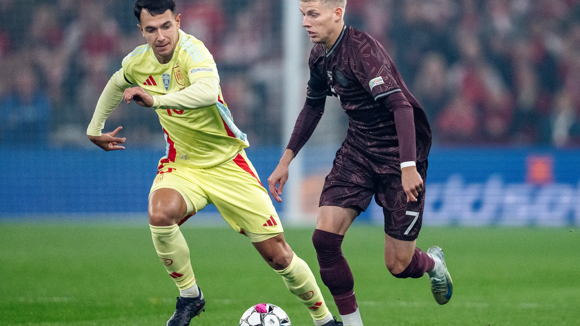 Denmark's Albert Groenbaek and Spain's Martin Zubimendi, left, in action during the UEFA Nations League match between Denmark and Spain at Parken in Copenhagen, Friday, Nov. 15, 2024. (Mads Claus Rasmussen/Ritzau Scanpix via AP)