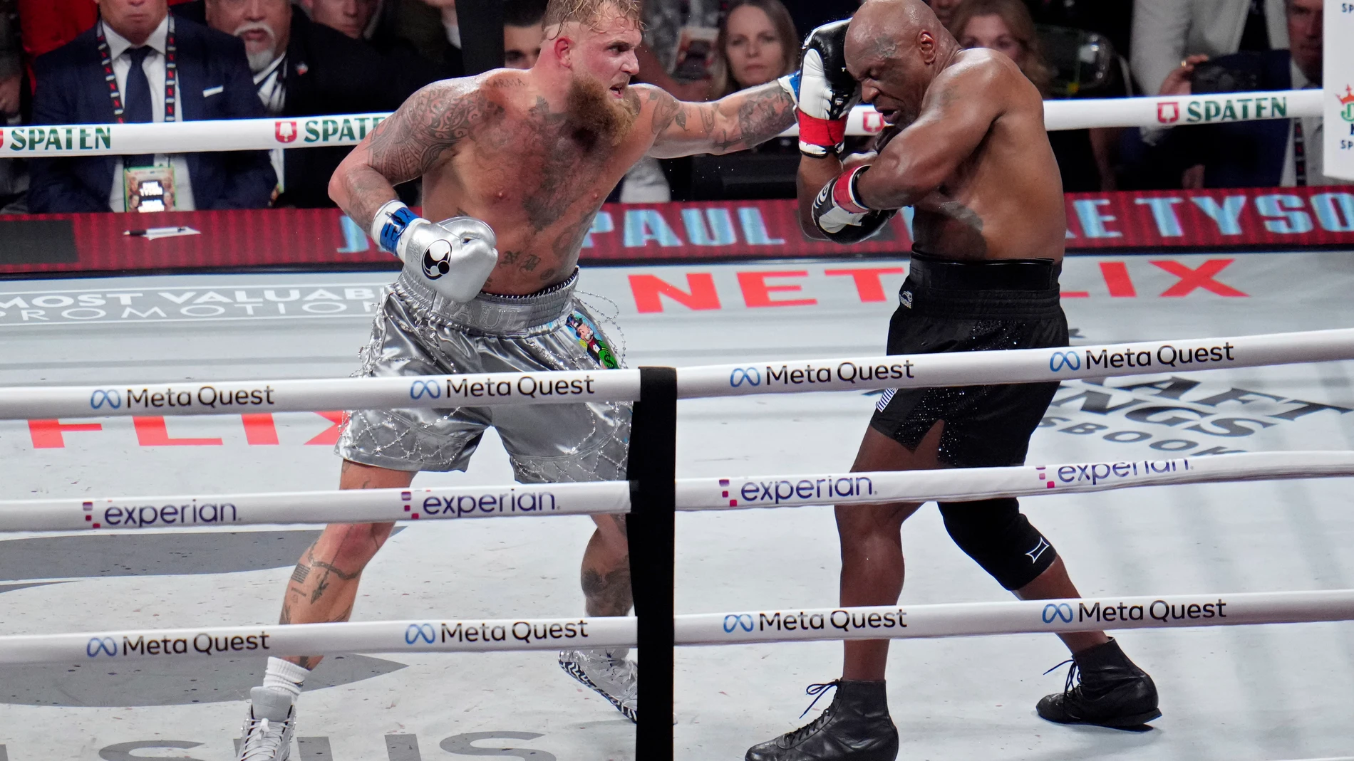 Jake Paul hits Mike Tyson during their heavyweight boxing match, Friday, Nov. 15, 2024, in Arlington, Texas. (AP Photo/Julio Cortez)