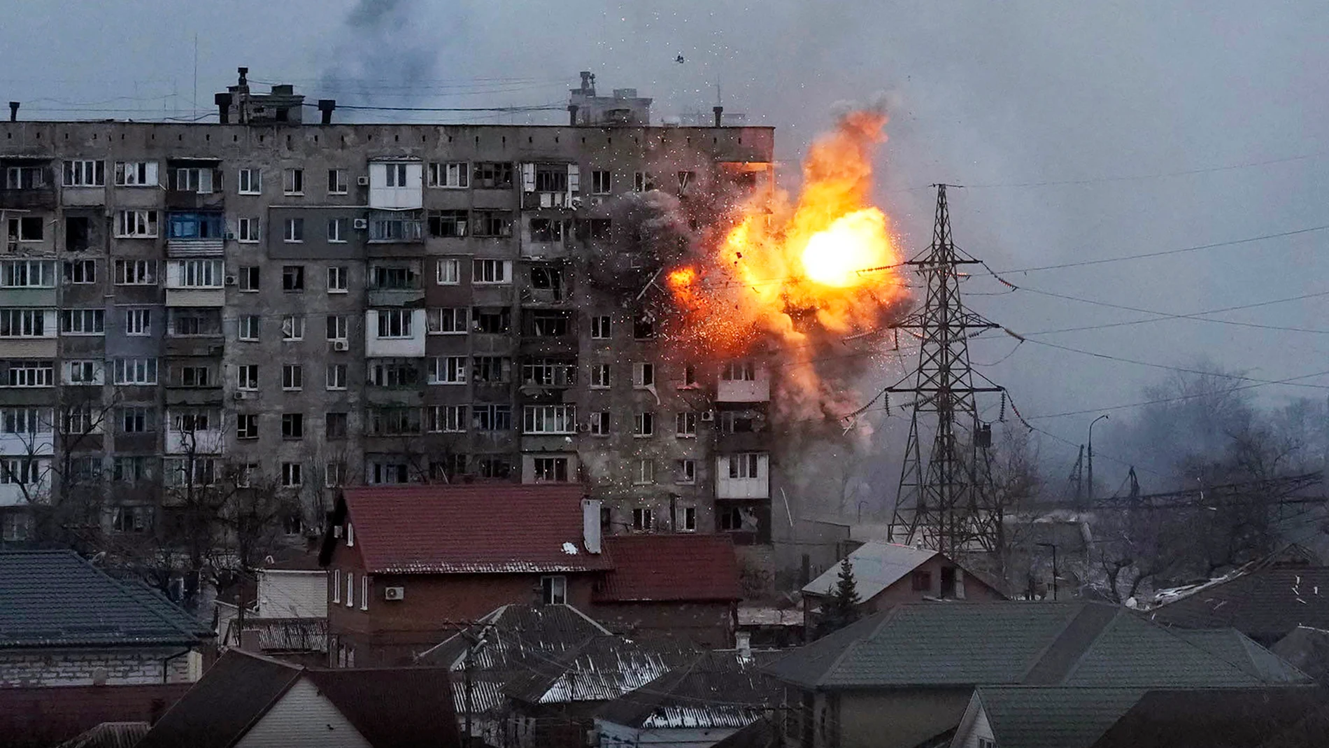 FILE - An explosion is seen in an apartment building after Russian's army tank fires in Mariupol, Ukraine, Friday, March 11, 2022. (AP Photo/Evgeniy Maloletka, File)
