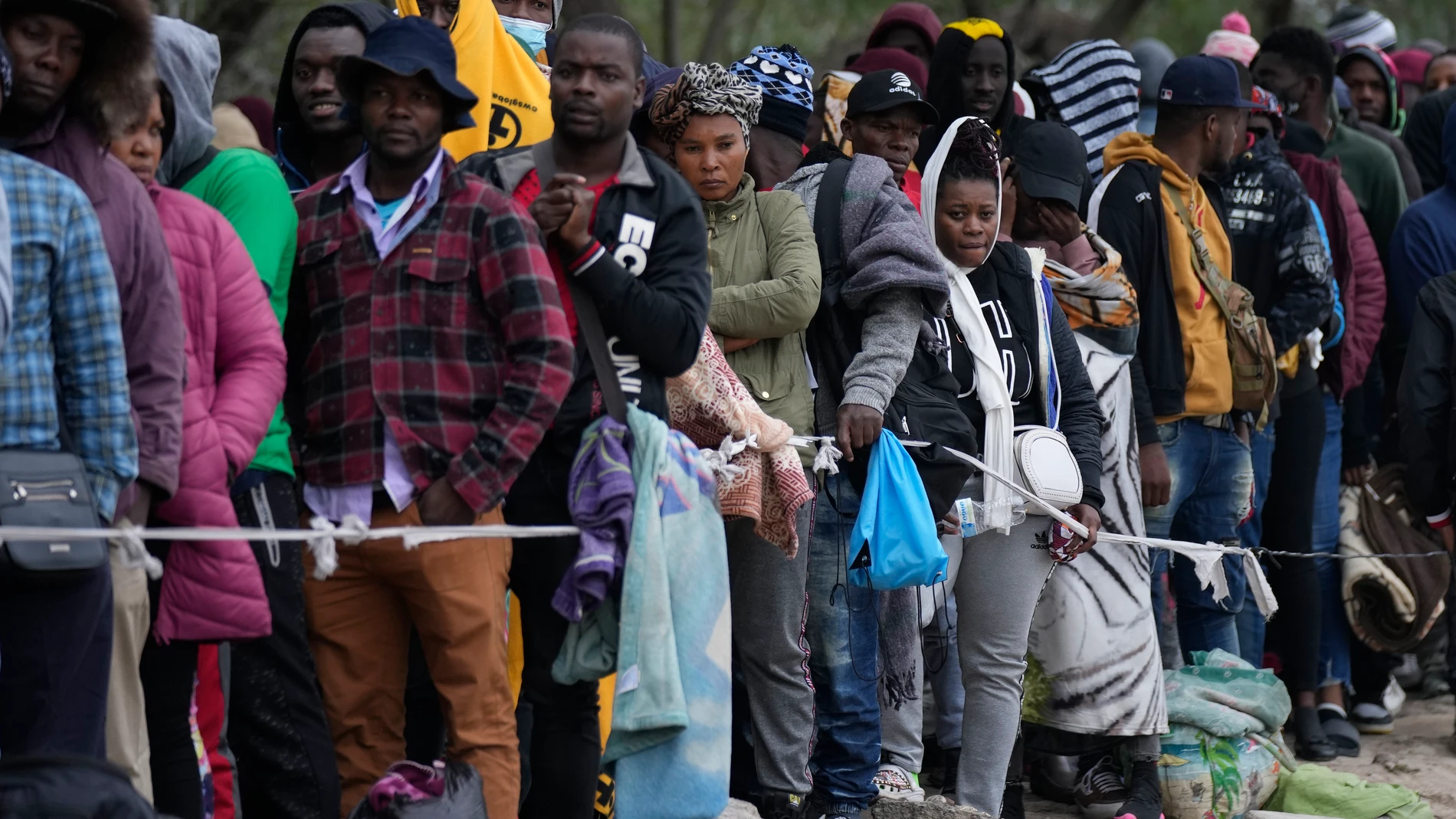 FILE - Haitian migrants who hope to apply for asylum in the U.S. wait to register their names on a list made by a religious organization in Reynosa, Mexico, Dec. 21, 2022, on the other side of the border with McAllen, Texas. (AP Photo/Fernando Llano, File)
