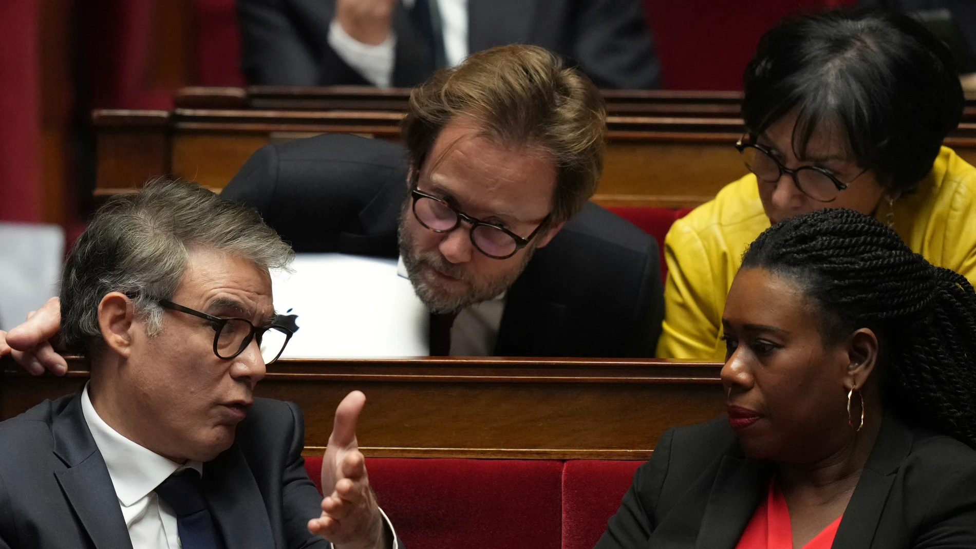 Socialist Party secretary general Olivier Faure, left, talks to socialists parliament members Boris Vallaud, top, and Dieynaba Diop, right, as French Prime Minister Francois Bayrou delivers his general policy speech, Tuesday, Jan. 14, 2025 at the National Assembly in Paris. (AP Photo/Thibault Camus)