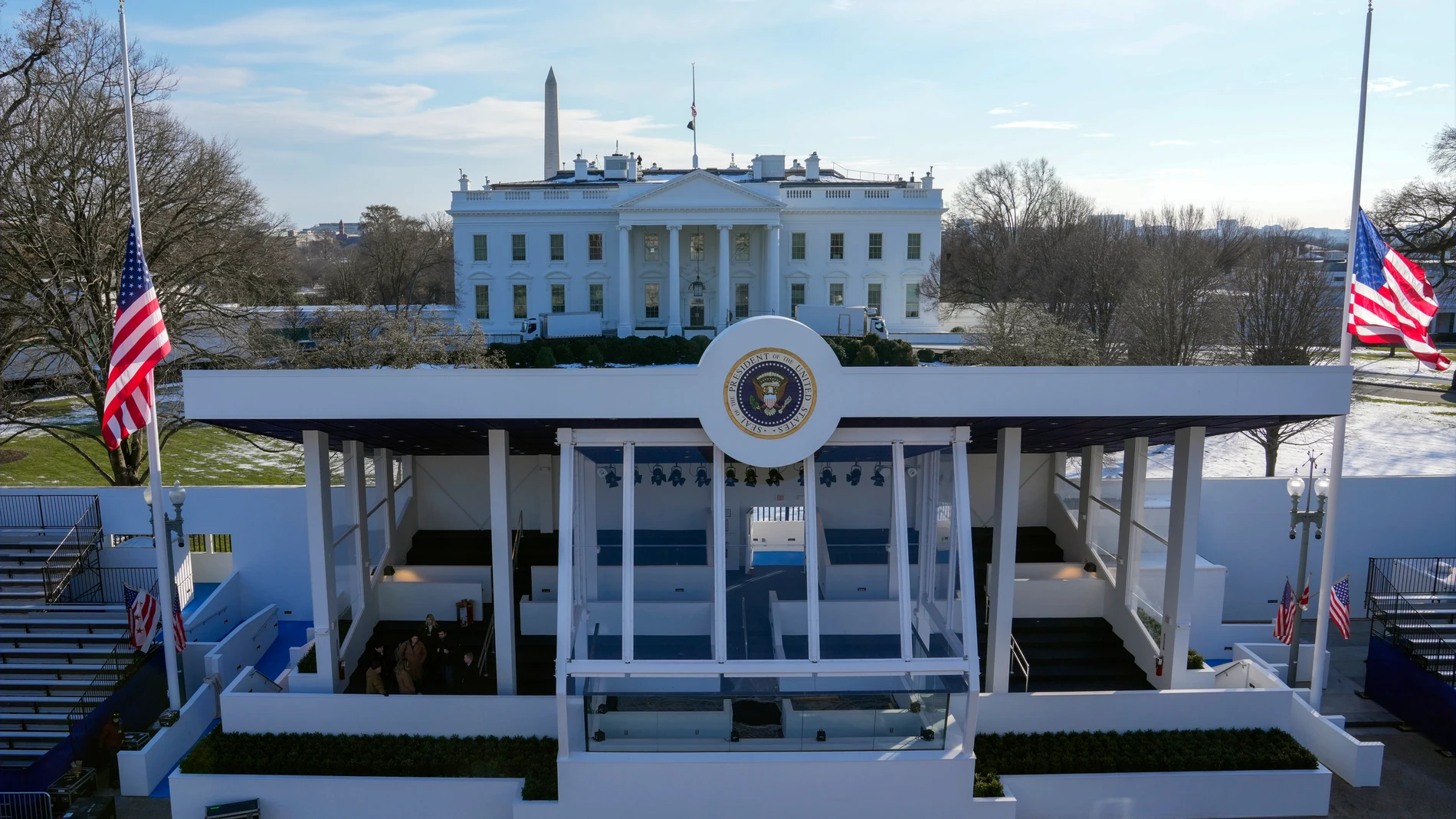 Workers continue with the finishing touches on the presidential reviewing stand on Pennsylvania outside the White House Thursday, Jan. 16, 2025, in Washington, ahead of President-elect Donald Trump's inauguration. (Jon Elswick via AP)