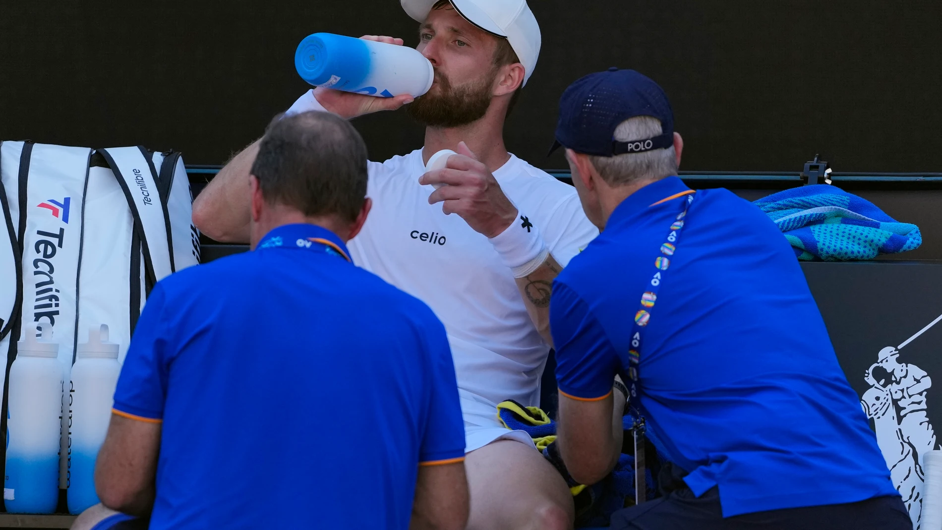 Corentin Moutet of France receives treatment from a trainer during his third round match against Learner Tien of the U.S. at the Australian Open tennis championship in Melbourne, Australia, Saturday, Jan. 18, 2025. (AP Photo/Vincent Thian)
