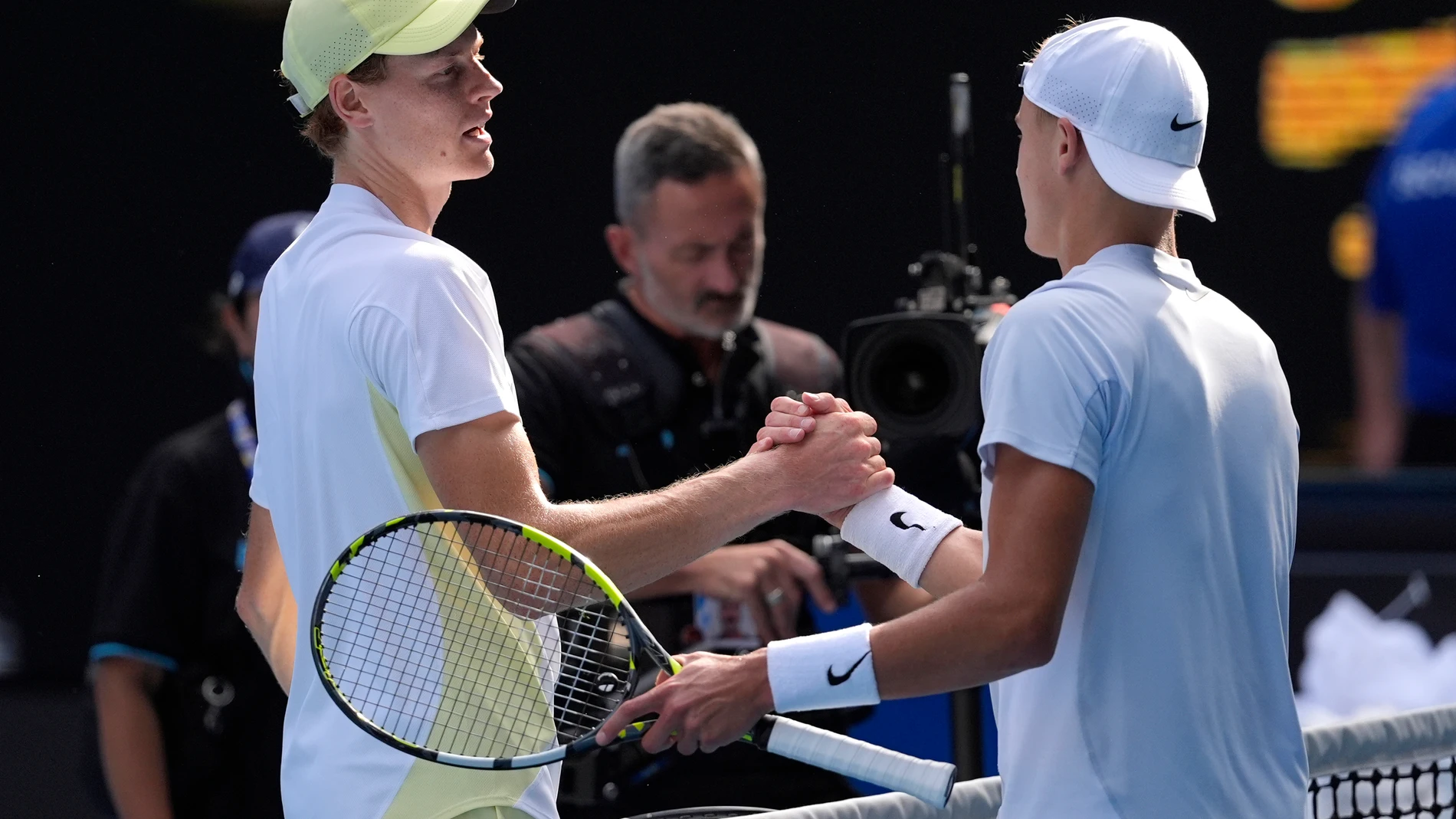 Jannik Sinner, left, of Italy is congratulated by Holger Rune of Denmark following their fourth round match at the Australian Open tennis championship in Melbourne, Australia, Monday, Jan. 20, 2025.(AP Photo/Asanka Brendon Ratnayake)