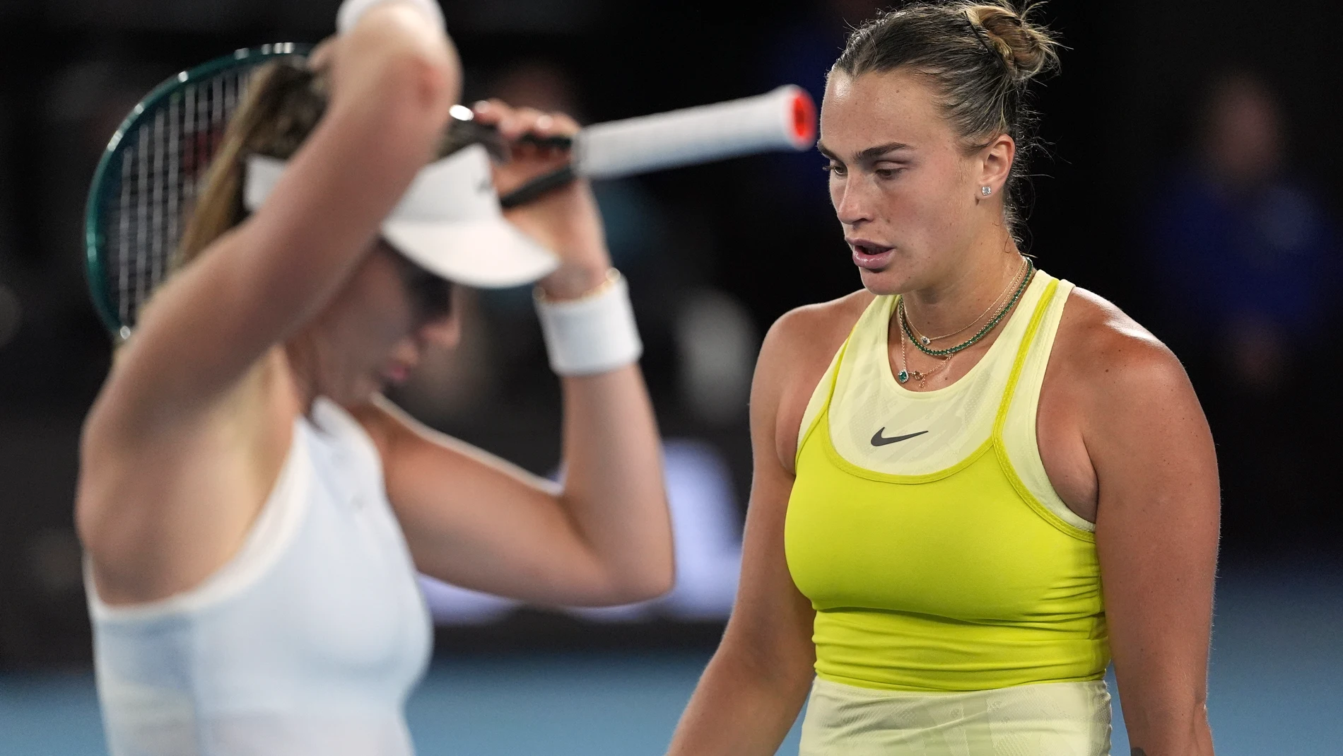 Aryna Sabalenka of Belarus walks past Paula Badosa of Spain during their semifinal match at the Australian Open tennis championship in Melbourne, Australia, Thursday, Jan. 23, 2025. (AP Photo/Ng Han Guan)