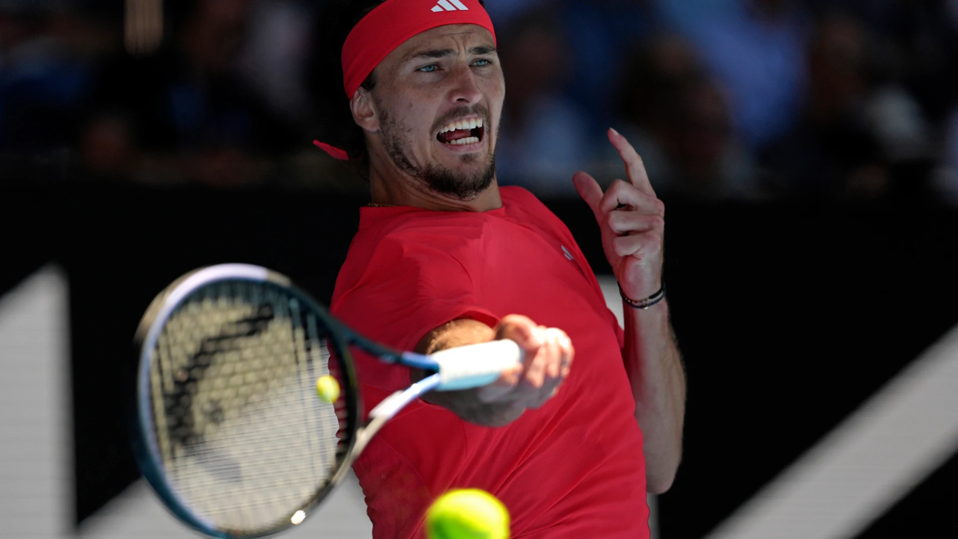 Alexander Zverev of Germany plays a forehand return to Novak Djokovic of Serbia during their semifinal match at the Australian Open tennis championship in Melbourne, Australia, Friday, Jan. 24, 2025. (AP Photo/Ng Han Guan)