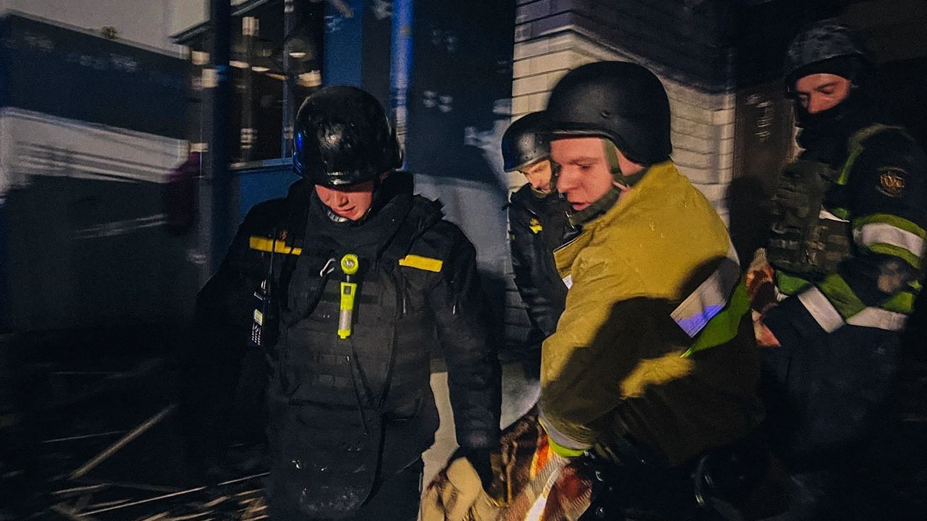 In this photo provided by the Ukrainian Emergency Service, emergency services personnel carry the body of a local resident after a Russian drone attack in Kyiv region, Ukraine, Friday, Jan. 24, 2025. (Ukrainian Emergency Service via AP)