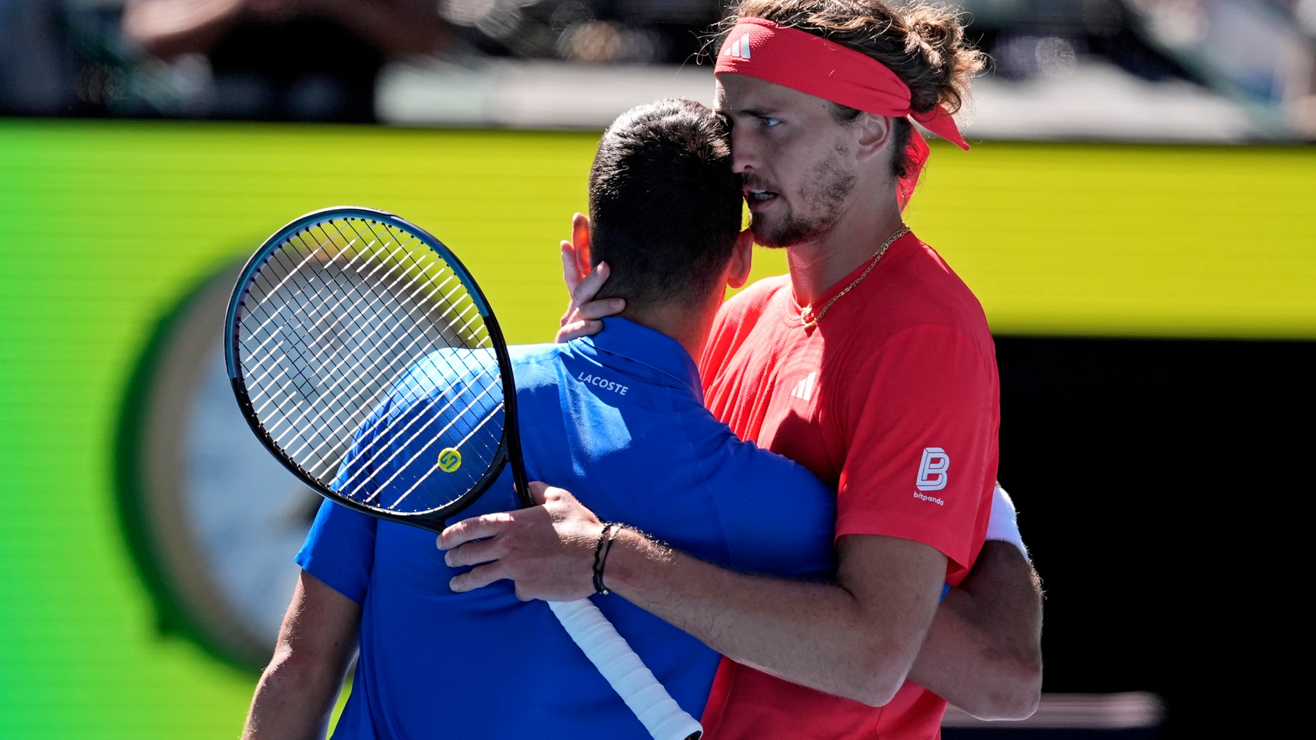 Alexander Zverev of Germany embraces Novak Djokovic of Serbia after Djokovic retired from their semifinal match at the Australian Open tennis championship in Melbourne, Australia, Friday, Jan. 24, 2025. (AP Photo/Ng Han Guan)