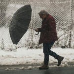 Un hombre se protege de la nieve en Pedrafita do Cebreiro