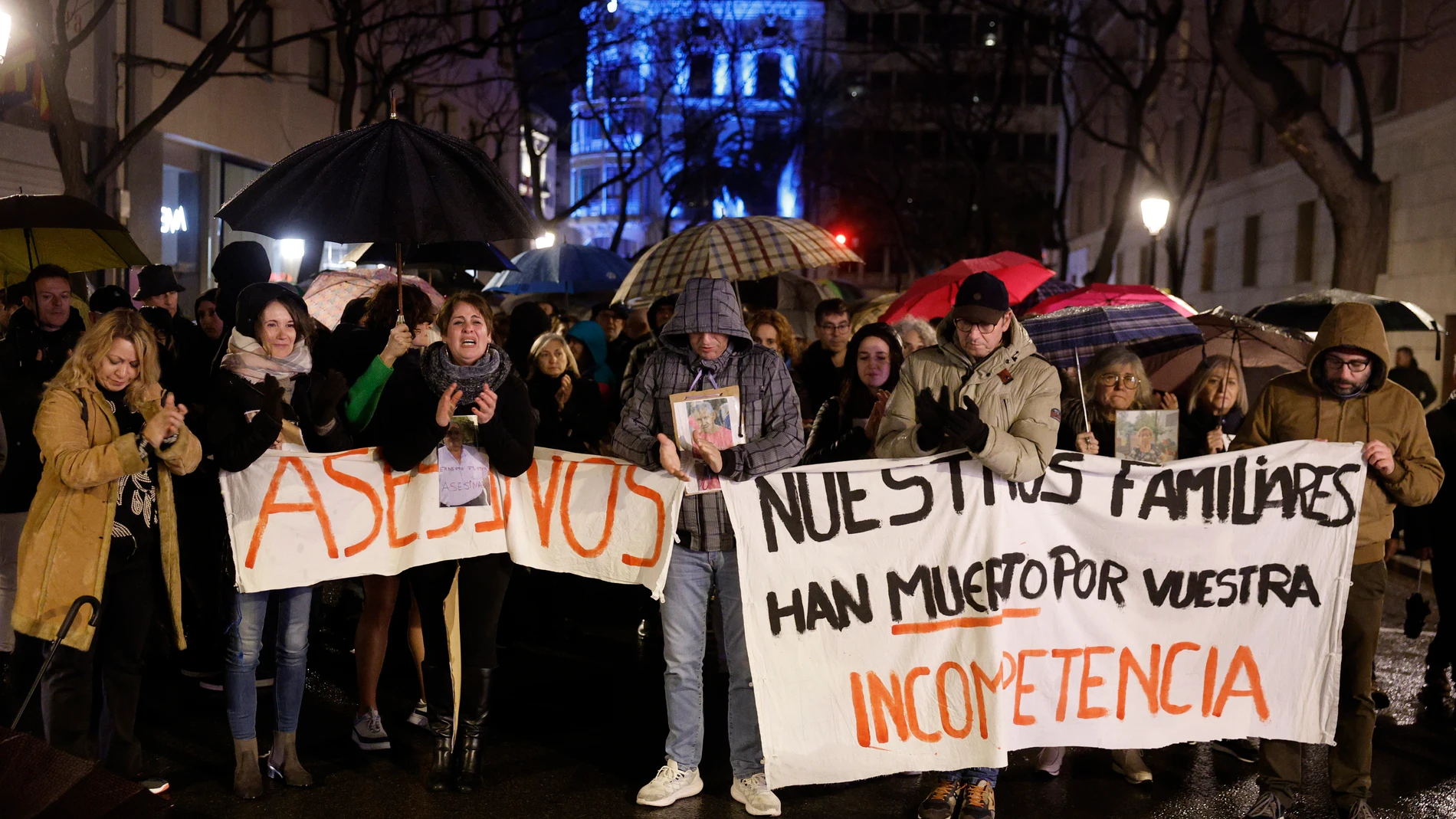 En la imagen, familiares de las víctimas aplauden en recuerdo de los fallecidos durante la manifestación