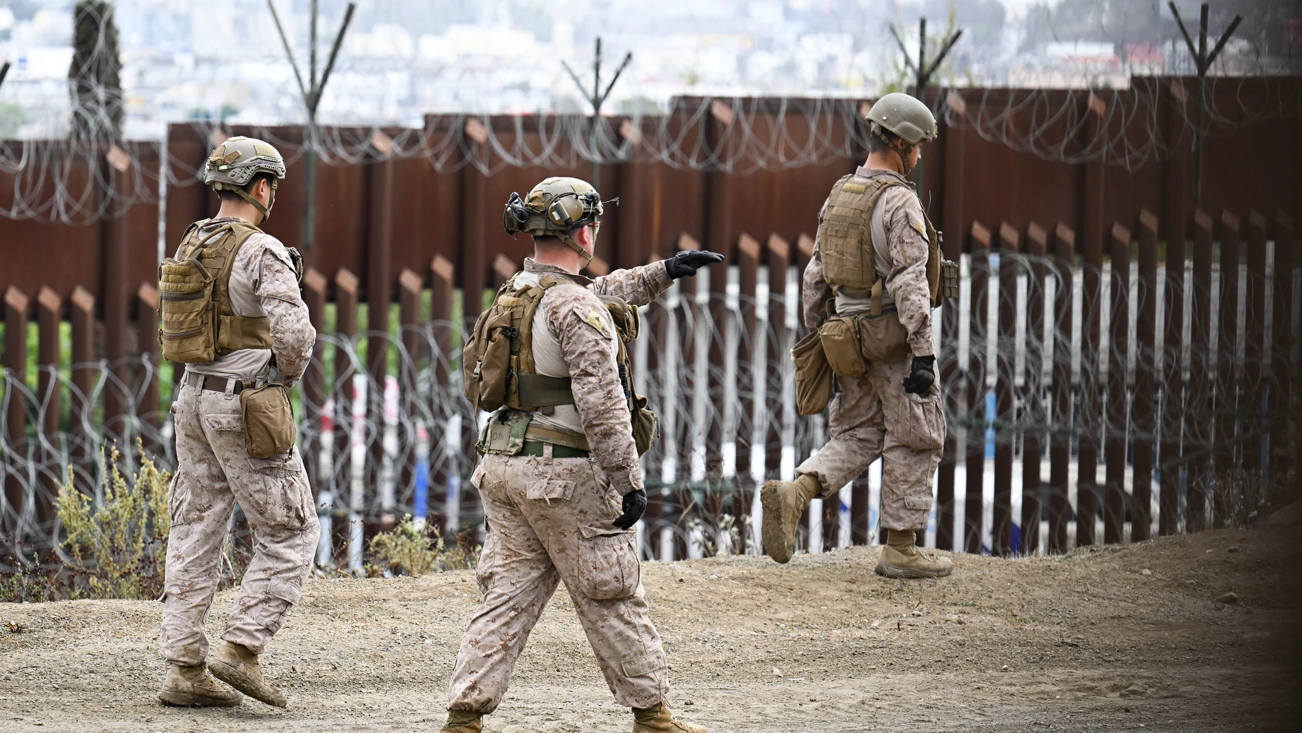 U.S. Marines deploy along the U.S.-Mexico border near the San Ysidro Port of Entry, Friday, Feb. 7, 2025, in San Diego with Tijuana, Mexico in the background. (AP Photo/Denis Poroy)