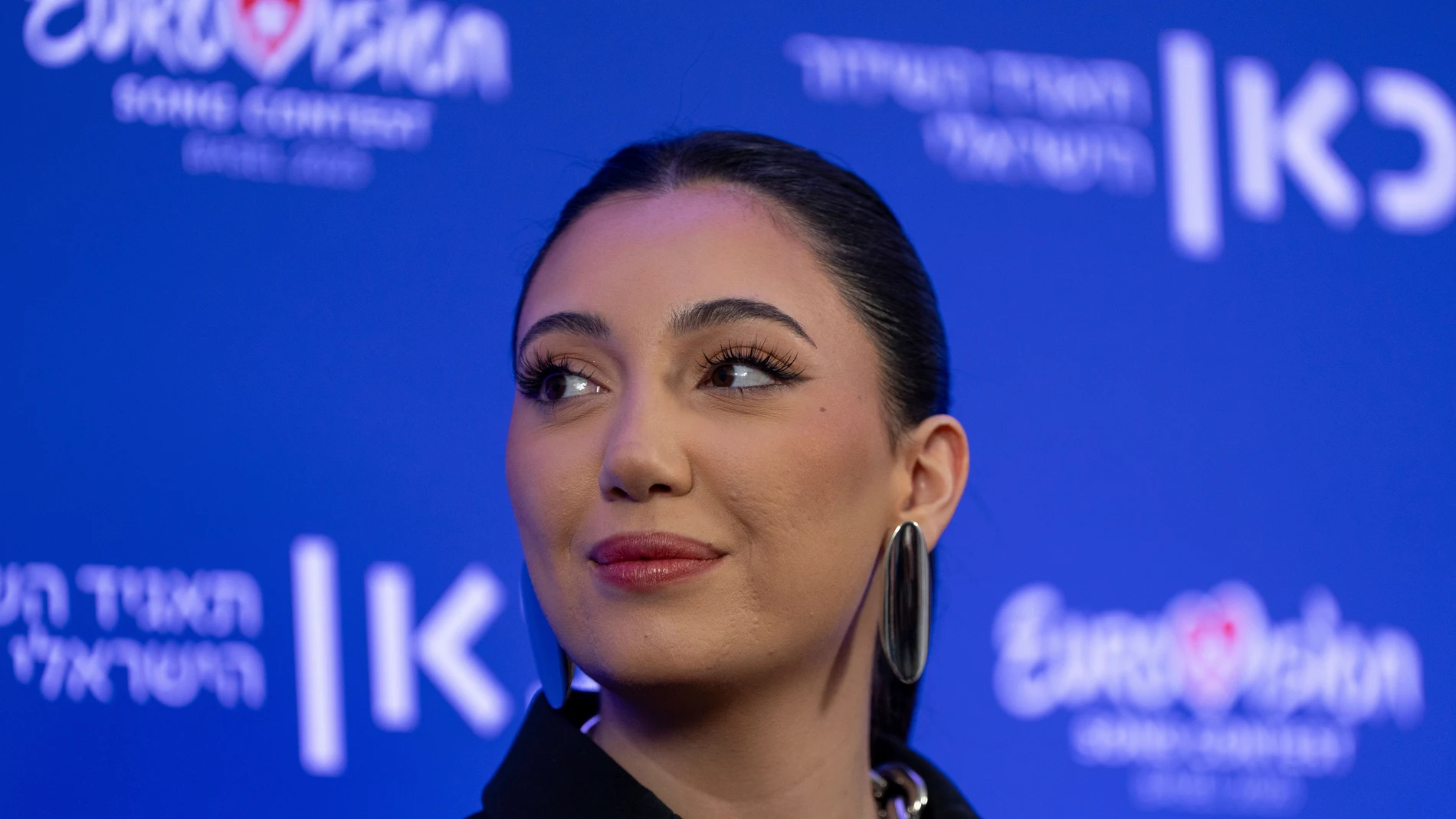 Yuval Raphael, Israel's Eurovision 2025 representative and survivor of the Oct. 7 attacks at the Nova music festival, speaks to the media after premiering the song "A New Day Will Rise," in Tel Aviv, Israel, Sunday, March 9, 2025. (AP Photo/Ohad Zwigenberg)