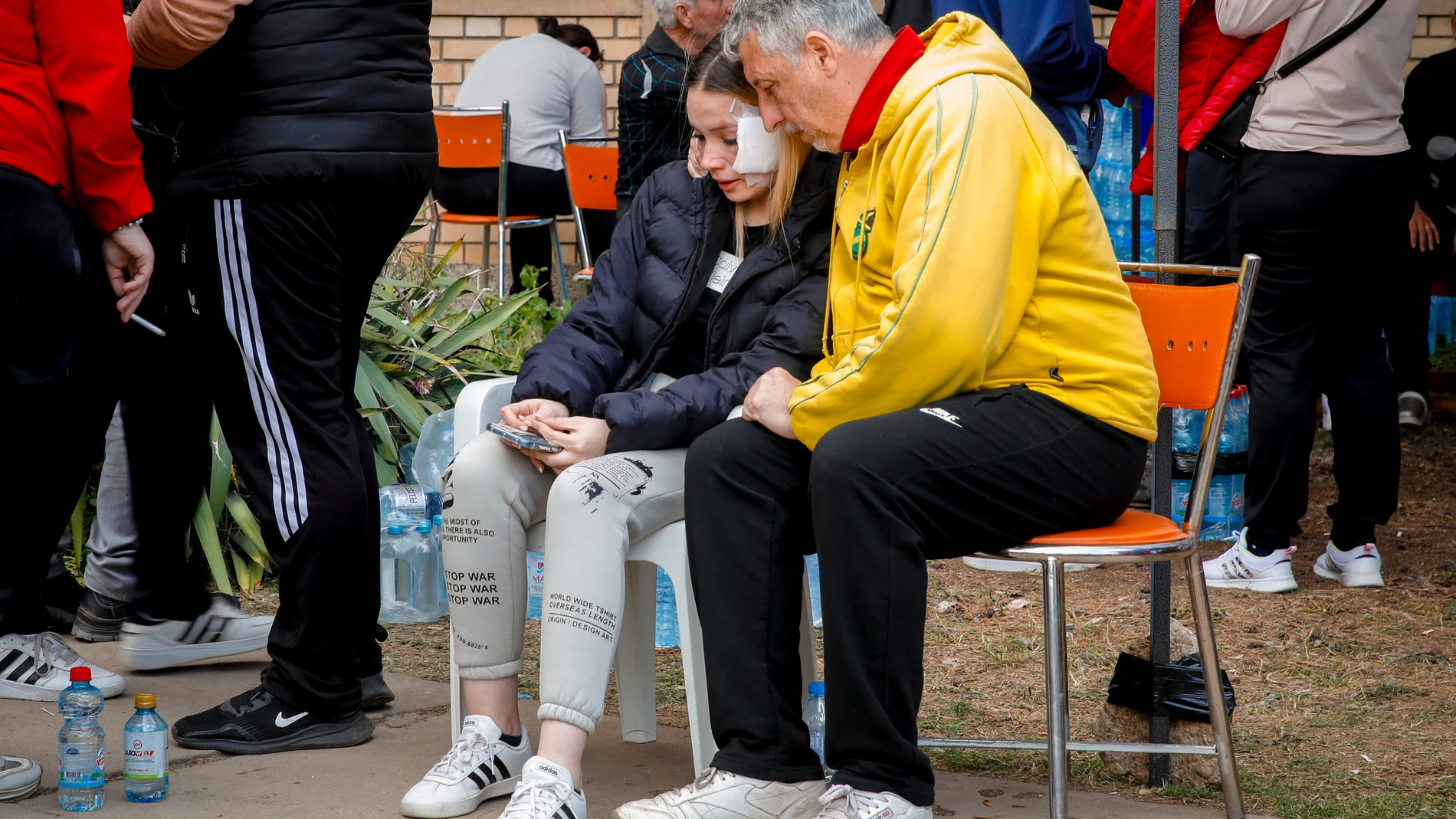 Maria Taseva, a 19 years-old survivor, who said her sister died in the fire, is comforted by a man outside a hospital in the town of Kocani, North Macedonia, Sunday, March 16, 2025, following a massive fire in the nightclub early Sunday. (AP Photo/Boris Grdanoski)