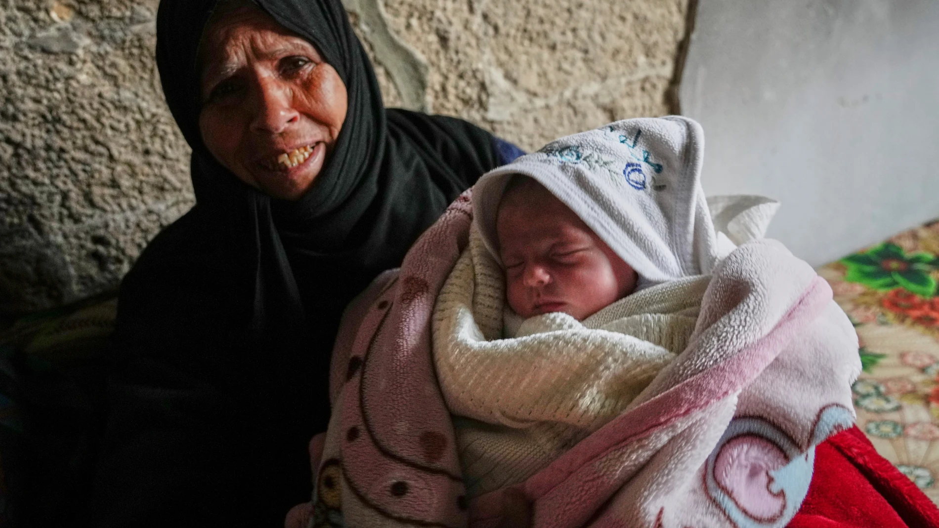 Ella Osama Abu Dagga, 25 days old, is held by her great-aunt Suad Abu Dagga after she was pulled from the rubble earlier following an Israeli army airstrike that killed her parents and brother in Khan Younis, southern Gaza Strip, Thursday, March 20, 2025. (AP Photo/Mariam Dagga)