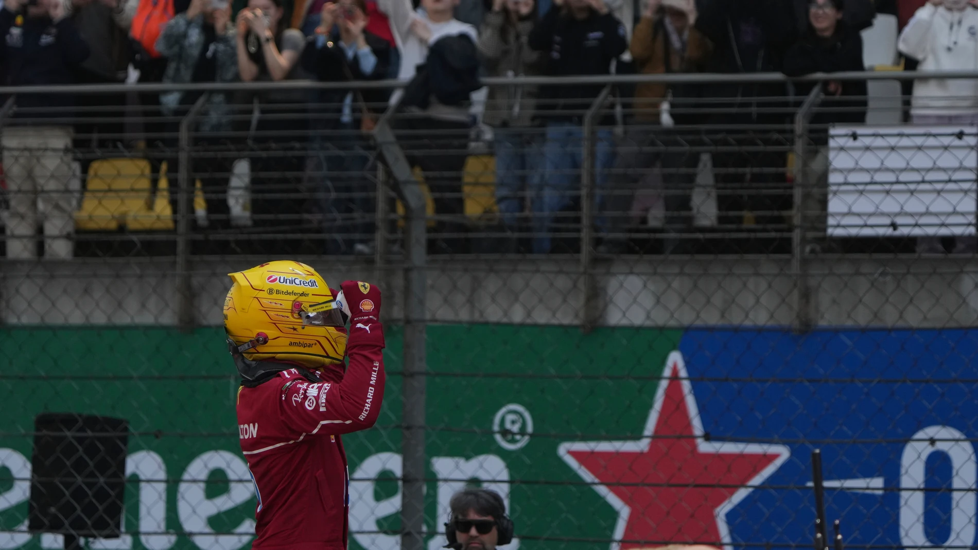 Ferrari driver Lewis Hamilton of Britain celebrates after winning the sprint race ahead of the Chinese Formula One Grand Prix at the Shanghai International Circuit, Shanghai, Saturday, March 22, 2025. (AP Photo/Andy Wong)