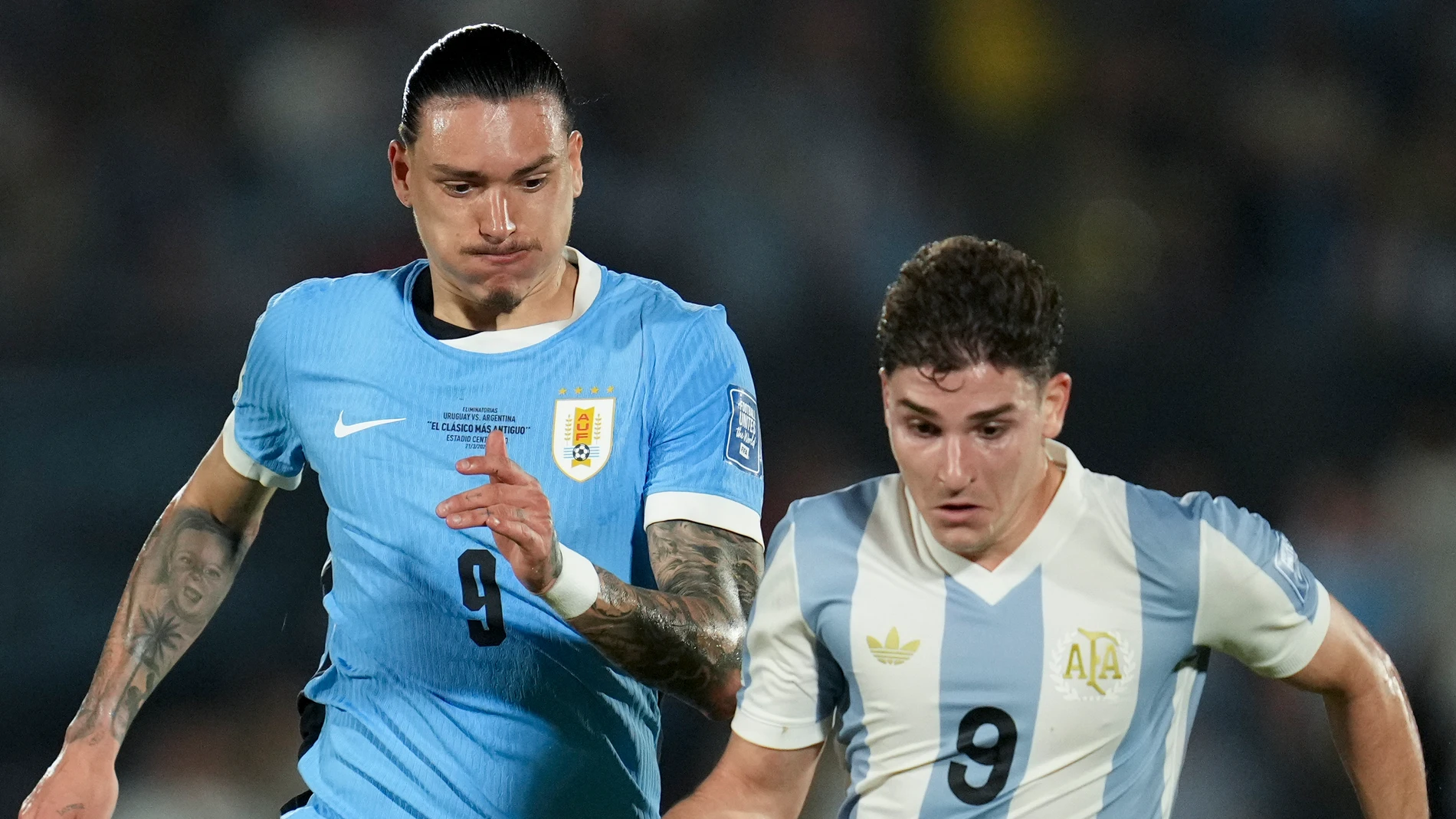 Argentina's Julian Alvarez, right, and Uruguay's Darwin Nunez battle for the ball during a qualifying soccer match for the FIFA World Cup 2026 in Montevideo, Uruguay, Friday, March 21, 2025. (AP Photo/Matilde Campodonico)