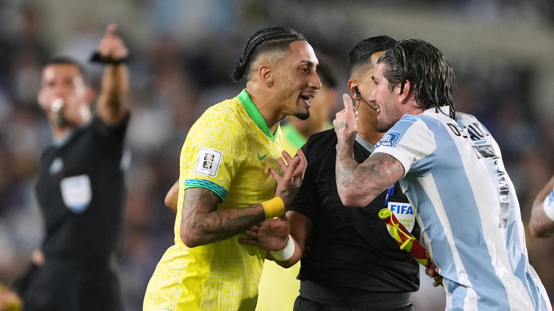 Brazil's Raphinha left, and Argentina's Rodrigo De Paul argue during a World Cup 2026 qualifying soccer match at Monumental Stadium in Buenos Aires, Argentina, Tuesday, March 25, 2025. (AP Photo/Natacha Pisarenko)