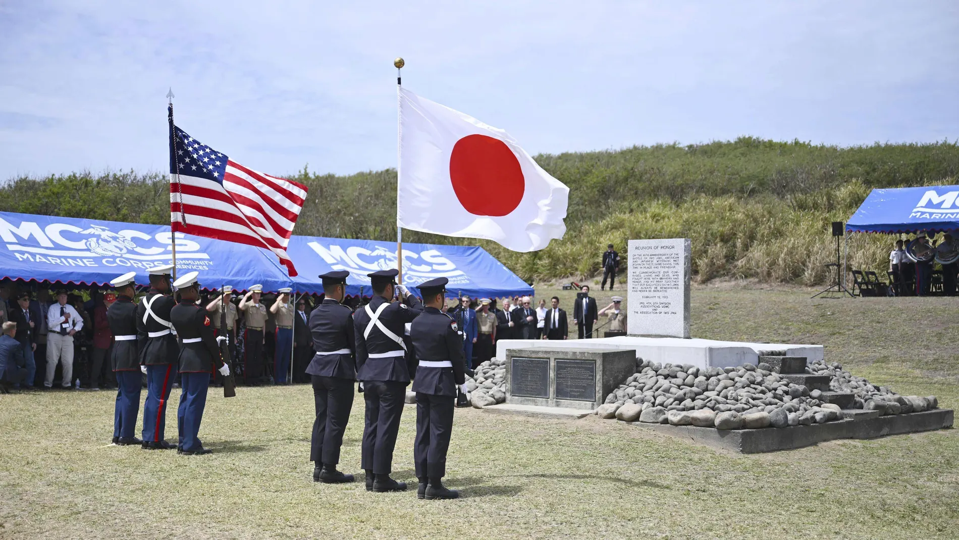 Japanese and the U.S. military personnel participate in the 80th Reunion of Honor joint ceremony where Japanese Prime Minister Shigeru Ishiba and U.S. Secretary of Defense Pete Hegseth attended on Iwo Jima, now known as Iwoto, or Iwo island, Japan, Saturday, March 29, 2025. (Japan Pool/Kyodo News via AP)