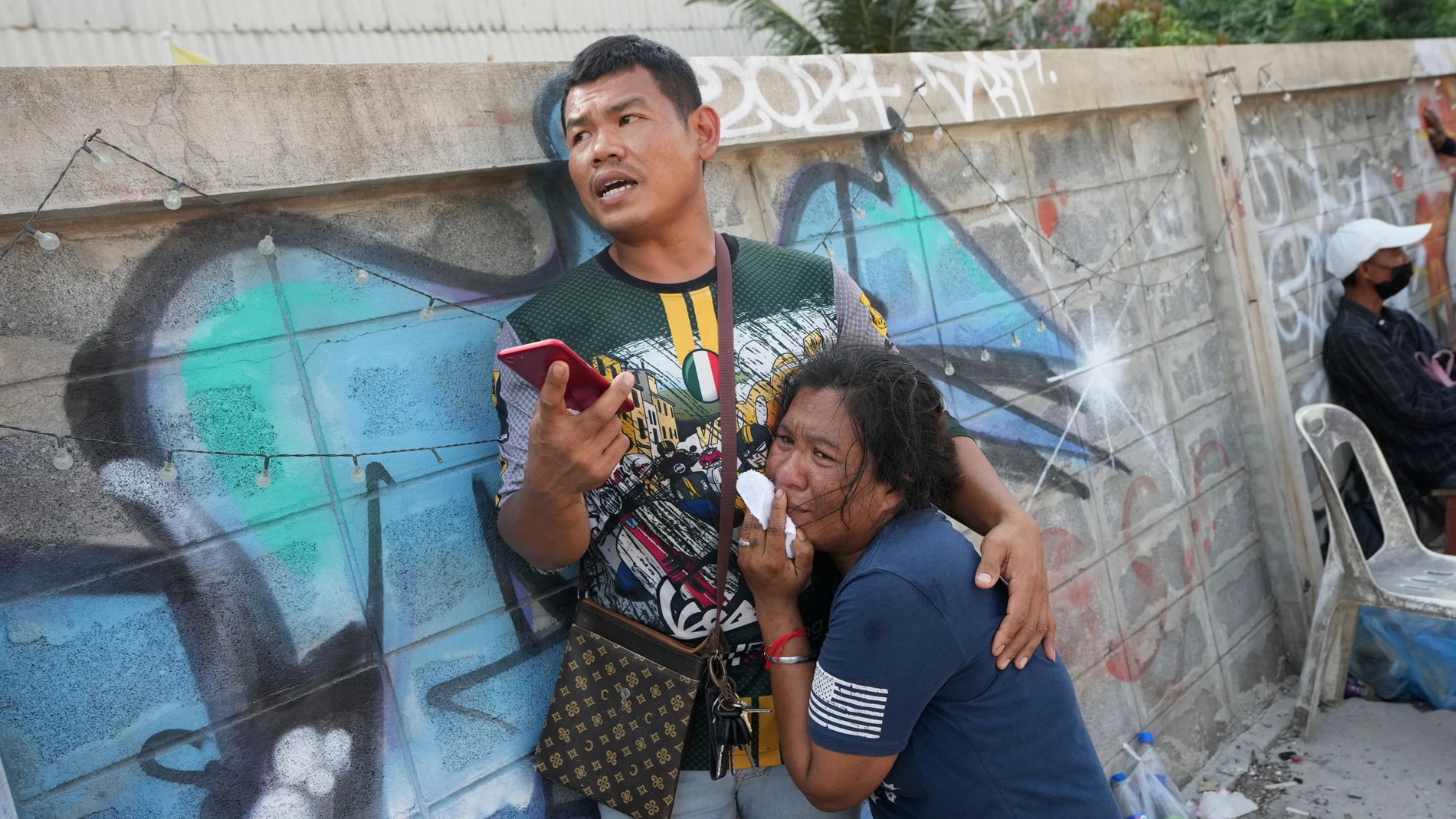 A woman weeps as rescue work is underway at the site of an under-construction high-rise building that collapsed on Friday after an earthquake in Bangkok, Thailand, Saturday, March 29, 2025. (AP Photo/Sakchai Lalit)