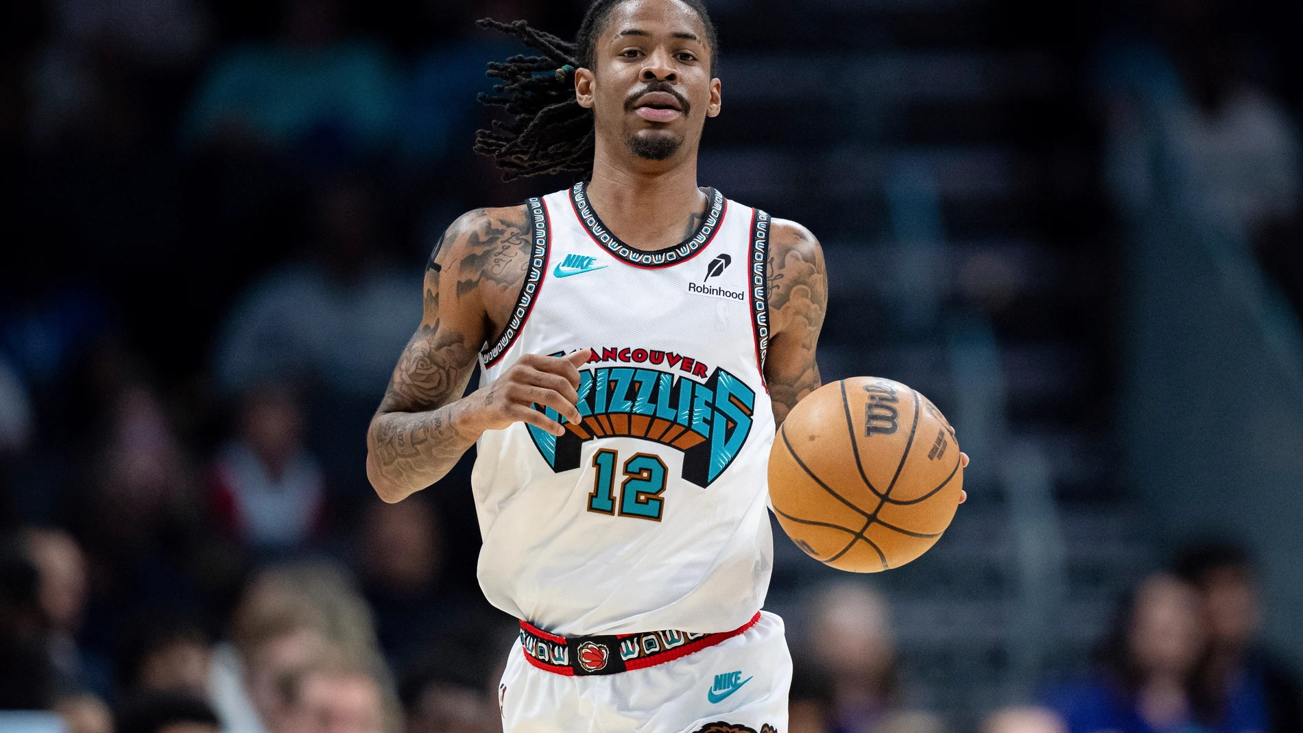 Memphis Grizzlies guard Ja Morant (12) brings the ball upcourt during the first half of an NBA basketball game against the Charlotte Hornets Tuesday, April 8, 2025, in Charlotte, N.C. (AP Photo/Jacob Kupferman)