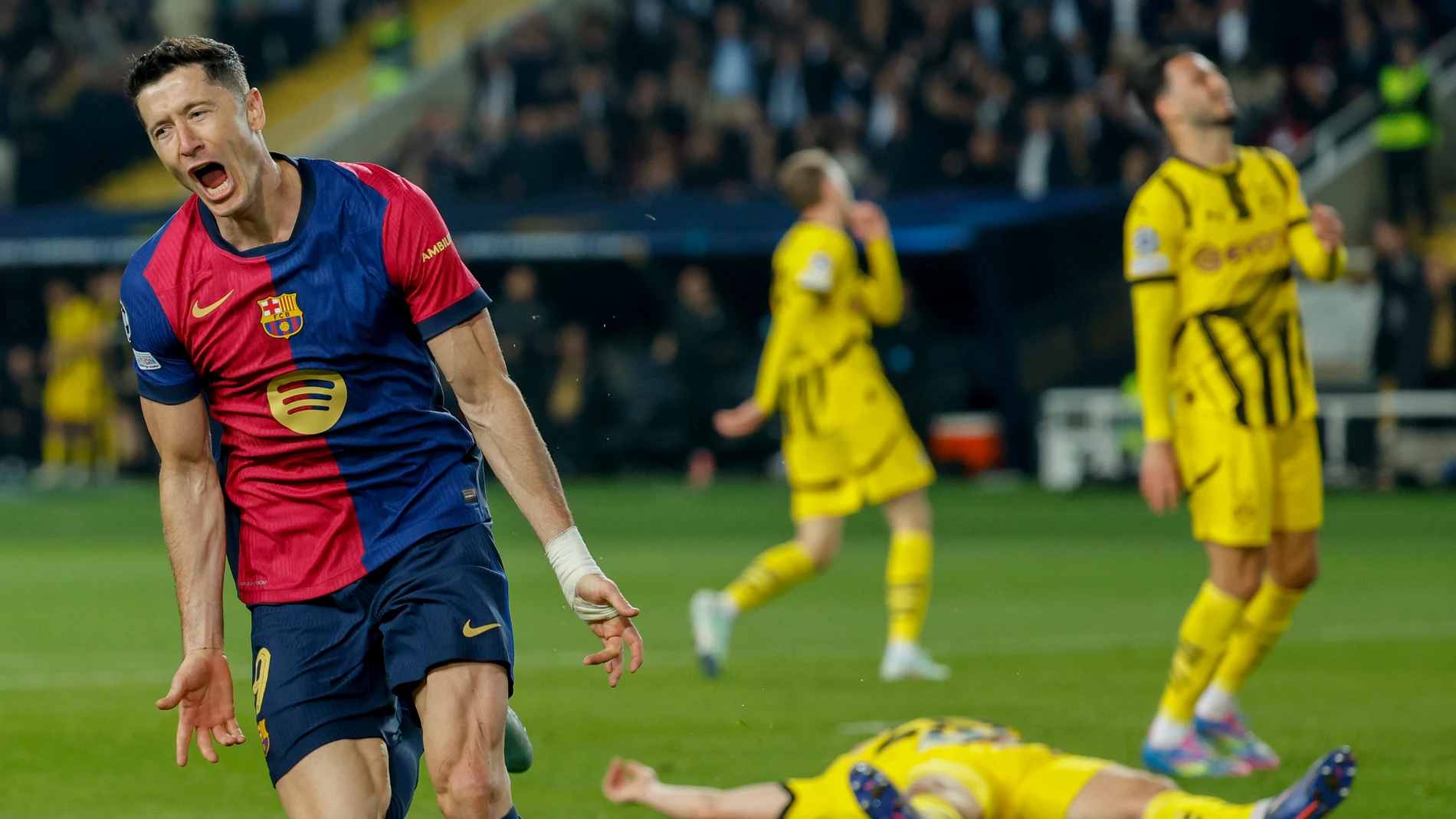 Barcelona's Robert Lewandowski celebrates after scoring his side's third goal during the Champions League quarterfinals first leg soccer match between Barcelona and Borussia Dortmund, at the Lluis Companys Olympic stadium in Barcelona, Spain, Wednesday, April 9, 2025. (AP Photo/Joan Monfort)