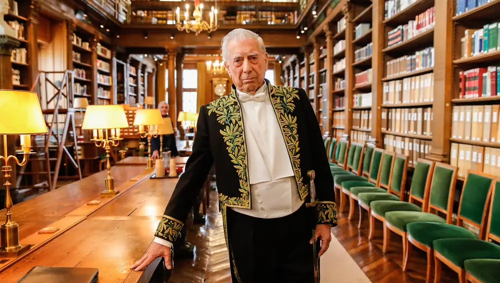 Peruvian-Spanish writer Mario Vargas Llosa poses for pictures in the library of the French Academy (Academie Francaise) in Paris, France