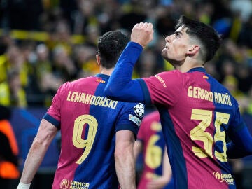Barcelona's Gerard Martin celebrates after forcing an own goal by Dortmund's Ramy Bensebaini during the Champions League quarterfinals second leg soccer match between Borussia Dortmund and Barcelona, at the Signa-Iduna Park in Dortmund, Germany, Tuesday, April 15, 2025. (AP Photo/Matthias Schrader)