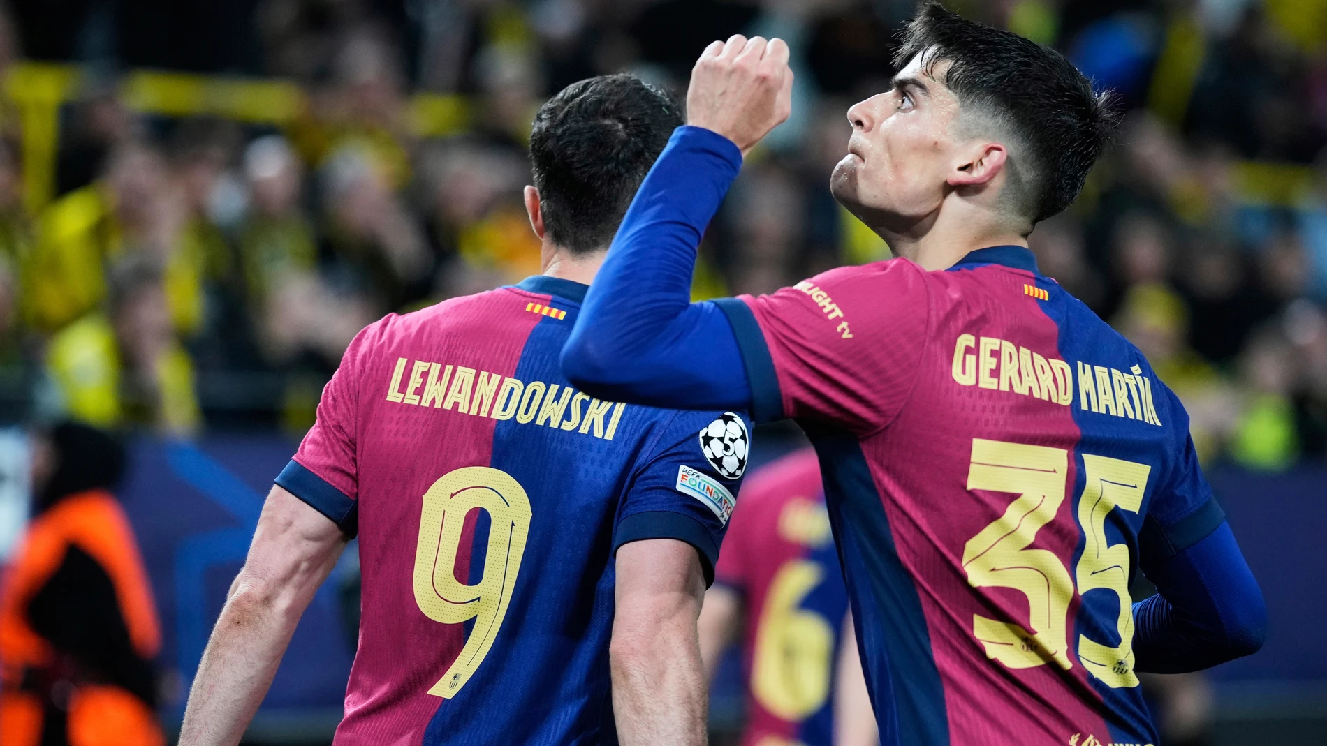 Barcelona's Gerard Martin celebrates after forcing an own goal by Dortmund's Ramy Bensebaini during the Champions League quarterfinals second leg soccer match between Borussia Dortmund and Barcelona, at the Signa-Iduna Park in Dortmund, Germany, Tuesday, April 15, 2025. (AP Photo/Matthias Schrader)