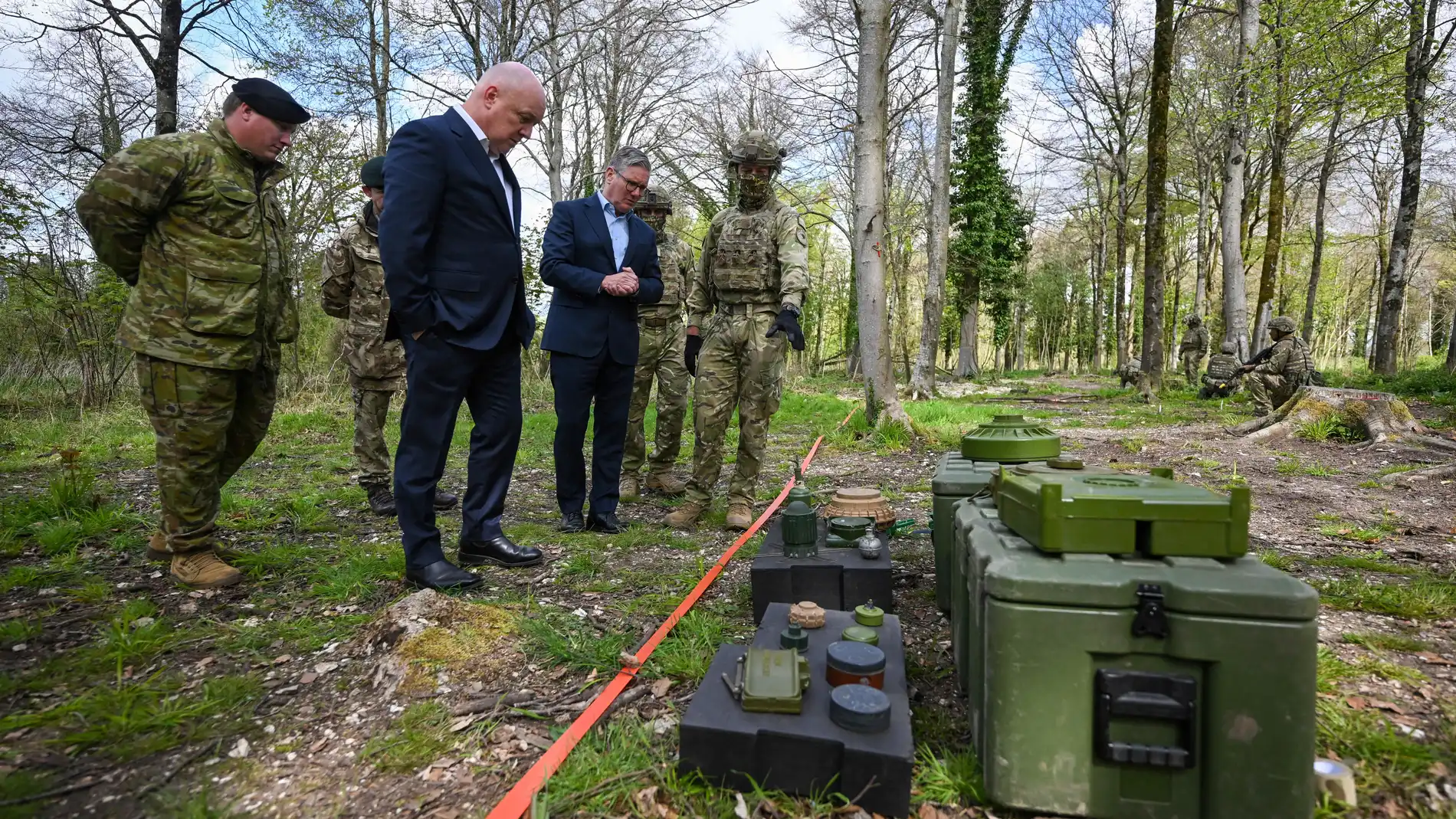Britain's Prime Minister Keir Starmer, center and New Zealand's Prime Minister Christopher Luxon speak to troops from New Zealand during a military base training Ukrainian troops, in the west of England, Tuesday, April 22, 2025. (Finnbarr Webster/Pool Photo via AP)