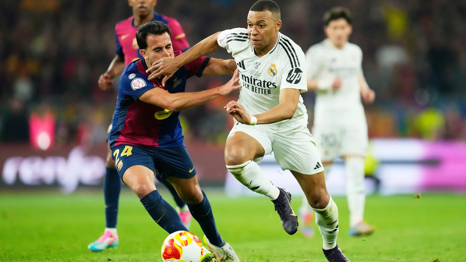 Real Madrid's Kylian Mbappe challenges for the ball with Barcelona's Eric Garcia during the Spanish Copa del Rey final soccer match between Barcelona and Real Madrid at Estadio de La Cartuja stadium in Seville, Spain, Saturday, April 26, 2025. (AP Photo/Jose Breton)