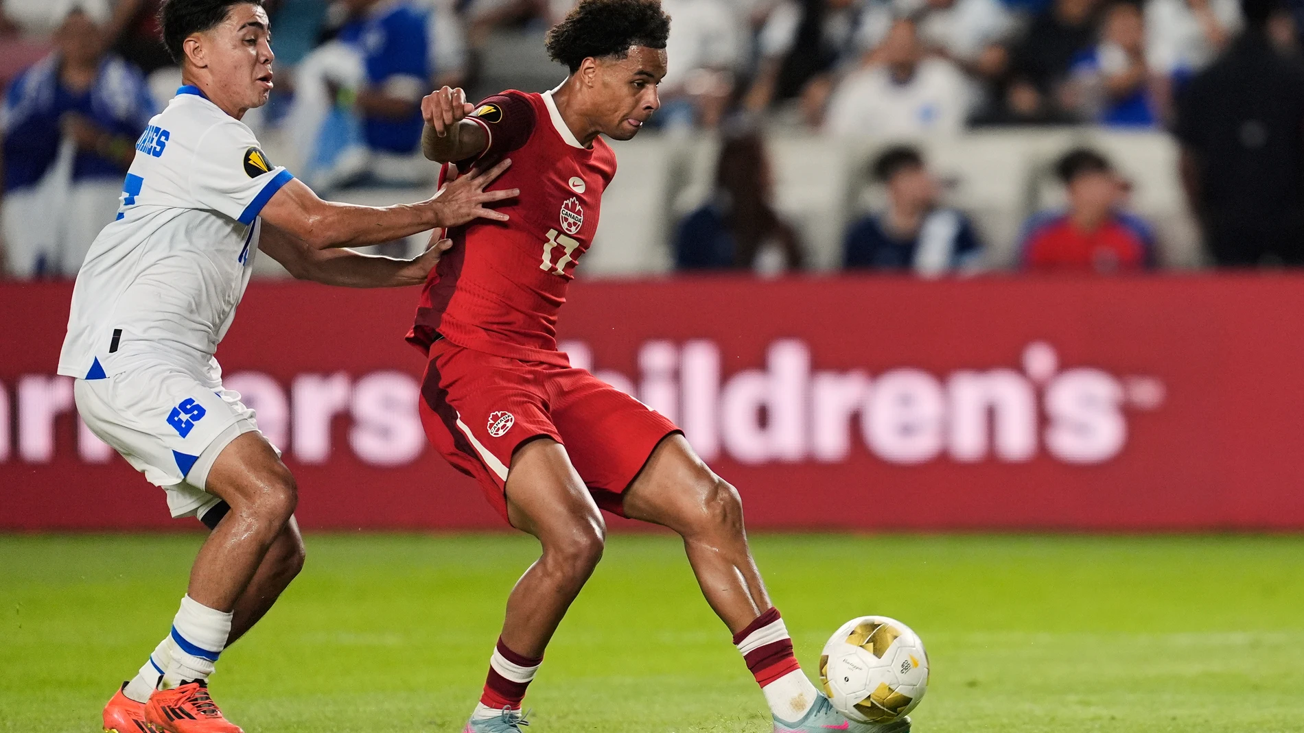 Canada forward Tajon Buchanan (17) scores against El Salvador defender Jefferson Valladares (15) during a CONCACAF Gold Cup soccer match in Houston, Tuesday, June 24, 2025. (AP Photo/Ashley Landis)