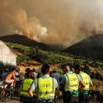 Members of the national gendarmerie force GNR gather as a wildfire burns in the village of Chao Sobral, central Portugal, 13 August 2025. The fire, which started in the nearby village of Piodao, has spread to neighbouring Arganil and other areas prompting the deployment of more than 600 firefighters. (incendio forestal) 