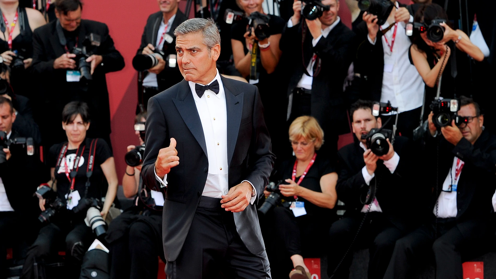 FILE - US actor George Clooney arrives on the red carpet for the premiere of his movie "The Ides of March," opening the 68th edition of the Venice Film Festival in Venice, Italy on Aug. 31, 2011. (AP Photo/Jonathan Short, File)