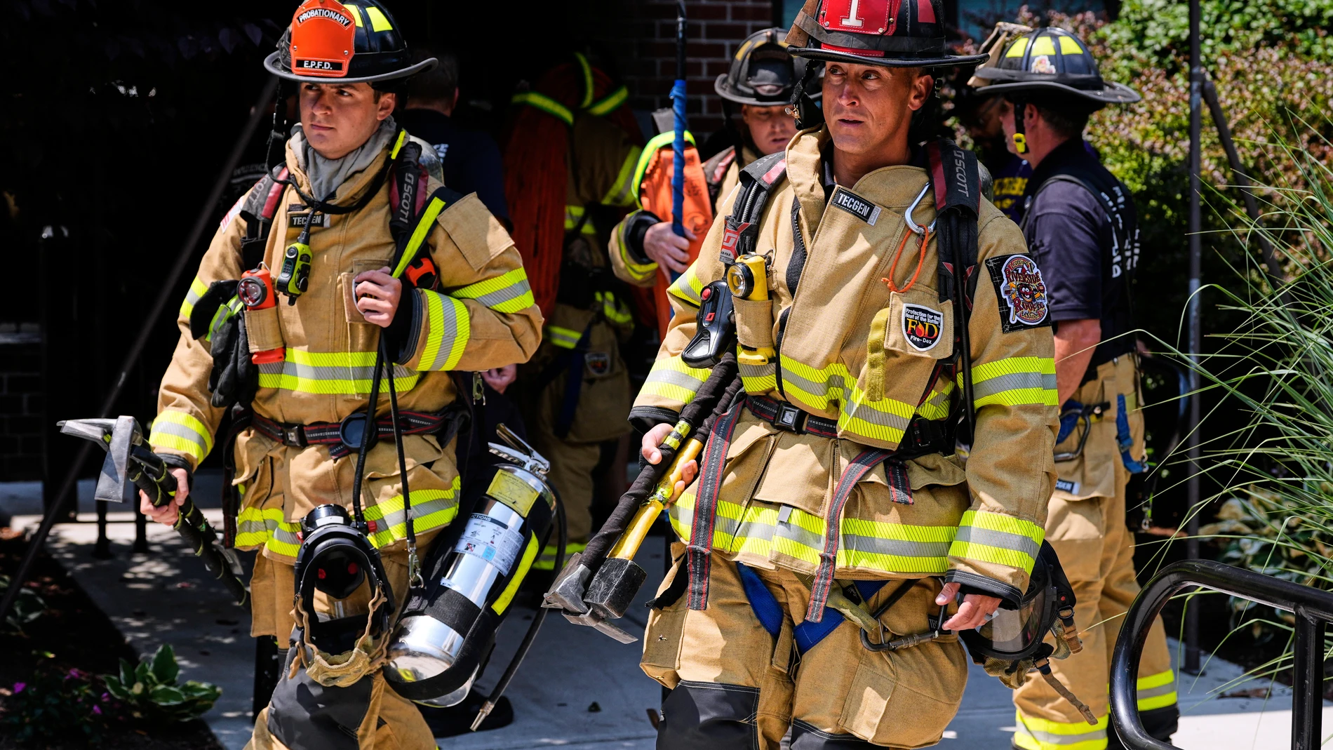 Firefighters respond to a fire while wearing recently issued non-PFAS turnout gear on July 3, 2025, in East Providence, R.I. (AP Photo/Charles Krupa)