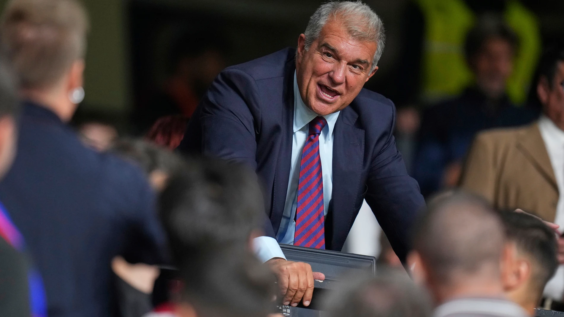 Barcelona soccer club president Joan Laporta speaks to spectators before the Spanish La Liga soccer match between Rayo Vallecano and FC Barcelona at the Vallecas stadium in Madrid, Spain, Sunday, Aug. 31, 2025. (AP Photo/Manu Fernandez)
